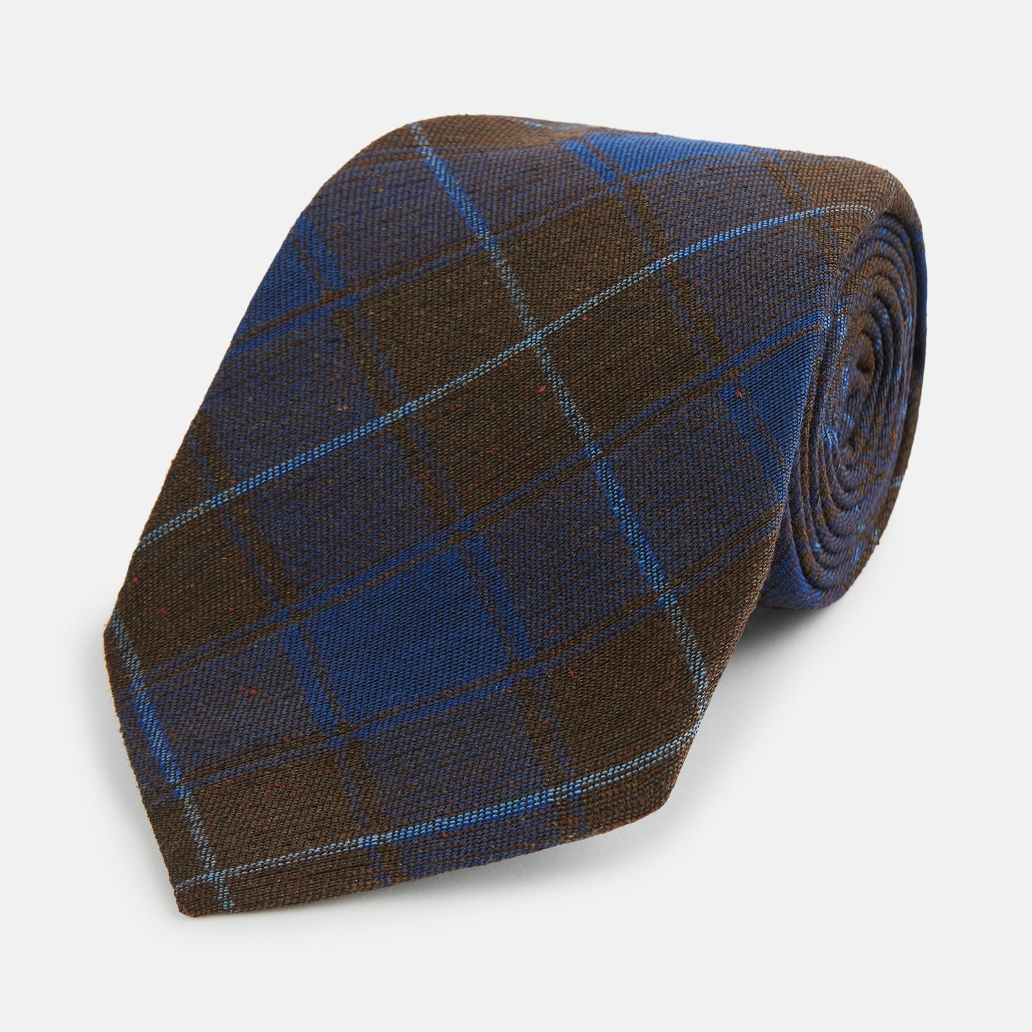 Image 1 of product The Turnbull & Asser Blue and Brown Tartan Silk Blend Tie, rolled up to show intersecting patterns, is displayed against a plain white background.