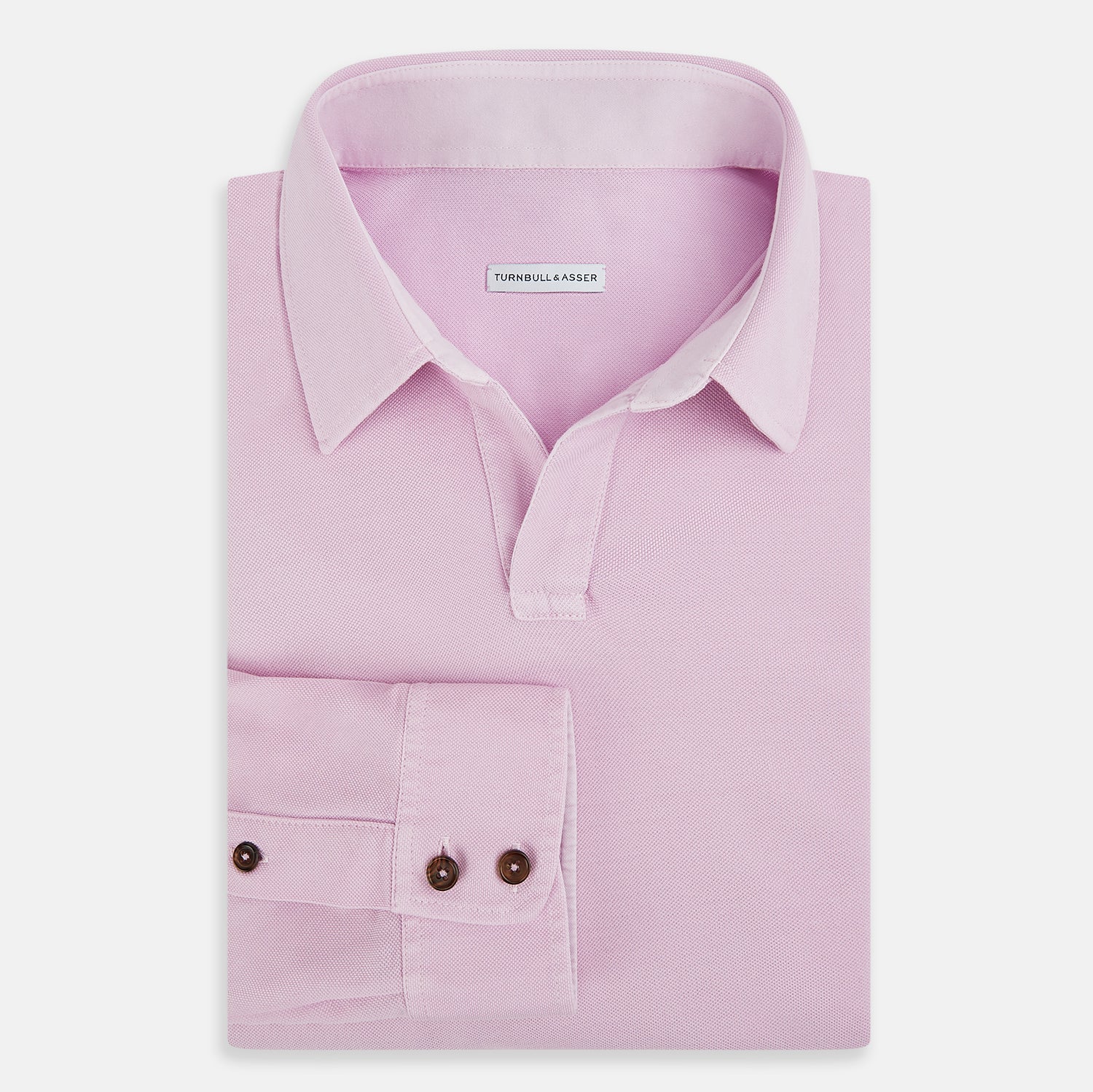 Image 5 of product The Pink Rugby Polo Shirt by Turnbull & Asser features long sleeves, a collar, and V-neck opening in luxury cotton, shown flat on a white background.