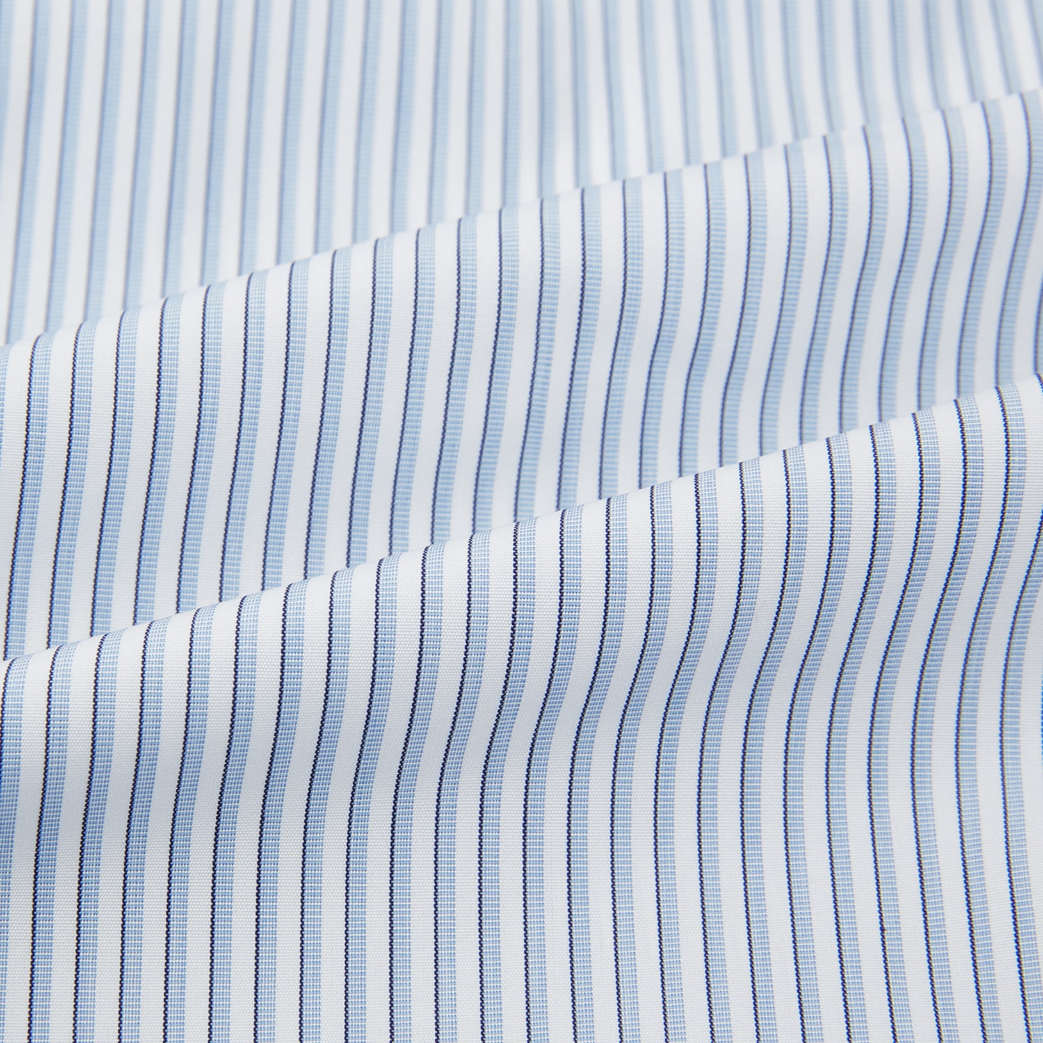 Image 6 of product The Turnbull & Asser Sky Blue Shadow Pinstripe Mayfair Shirt, a long-sleeved, button-up shirt with a T&A collar and light blue and white thin vertical stripes, is displayed flat on a white background.