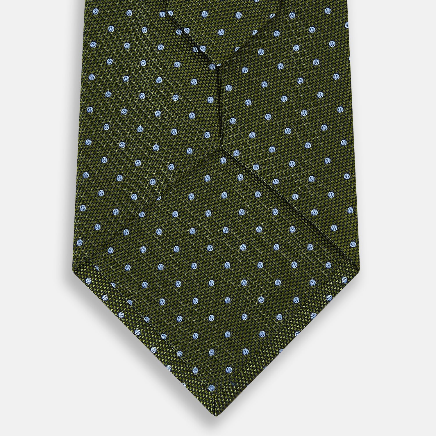 Image 8 of product The Turnbull & Asser Green and Blue Micro Dot Silk Tie is shown rolled up, displaying small light blue dots on green silk against a plain white background.