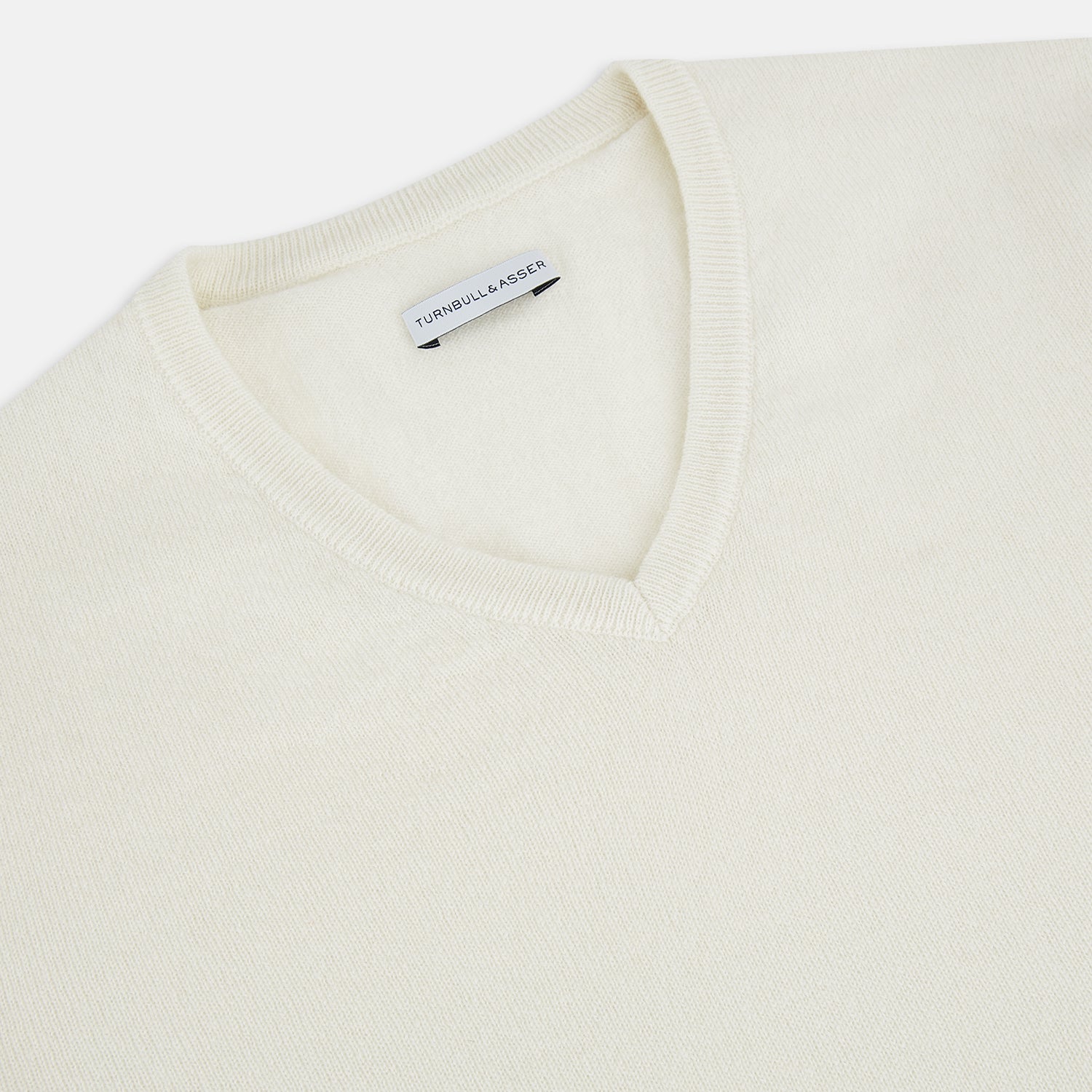 Image 2 of product The Turnbull & Asser White Cashmere V-Neck Jumper features long sleeves and a versatile light cream shade, making it a timeless addition to your knitwear collection.
