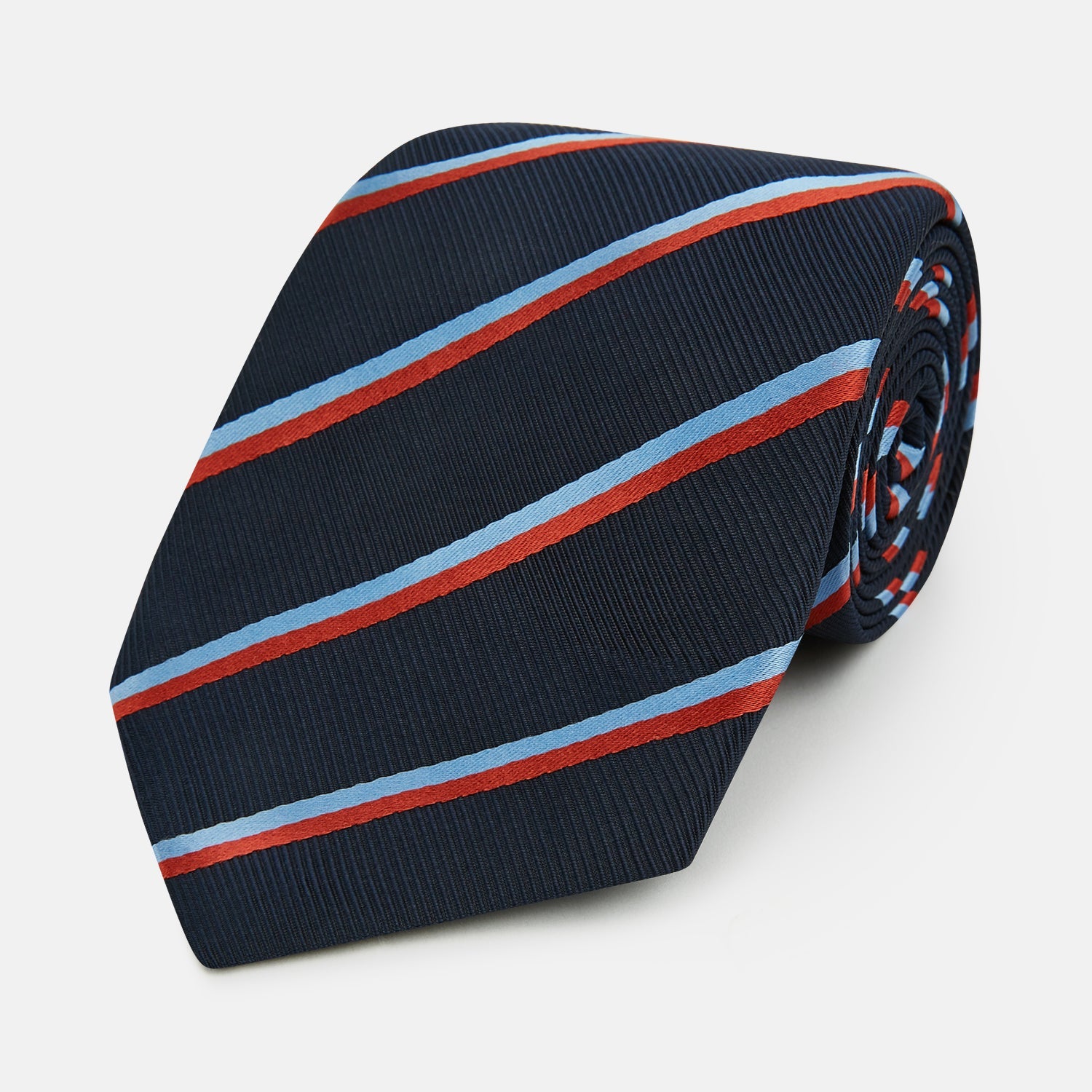 Image 1 of product The Turnbull & Asser Red And Blue Stripe Silk Blend Tie, rolled on a white background, features refined diagonal accents—an elegant formal accessory.