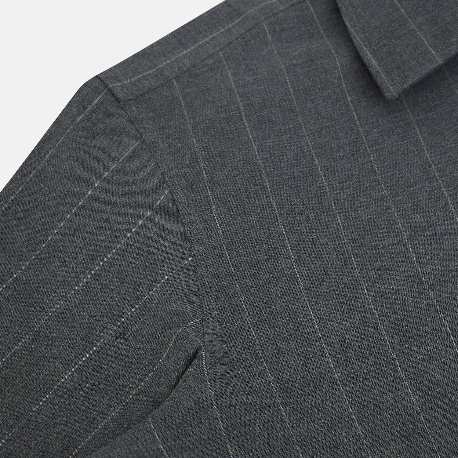 Image 6 of product The Charcoal Melange Wide Stripe Westminster Shirt from Turnbull & Asser features long sleeves, a tailored fit, pointed collar, buttoned cuffs, and subtle wide stripes, shown laid flat on a white background.