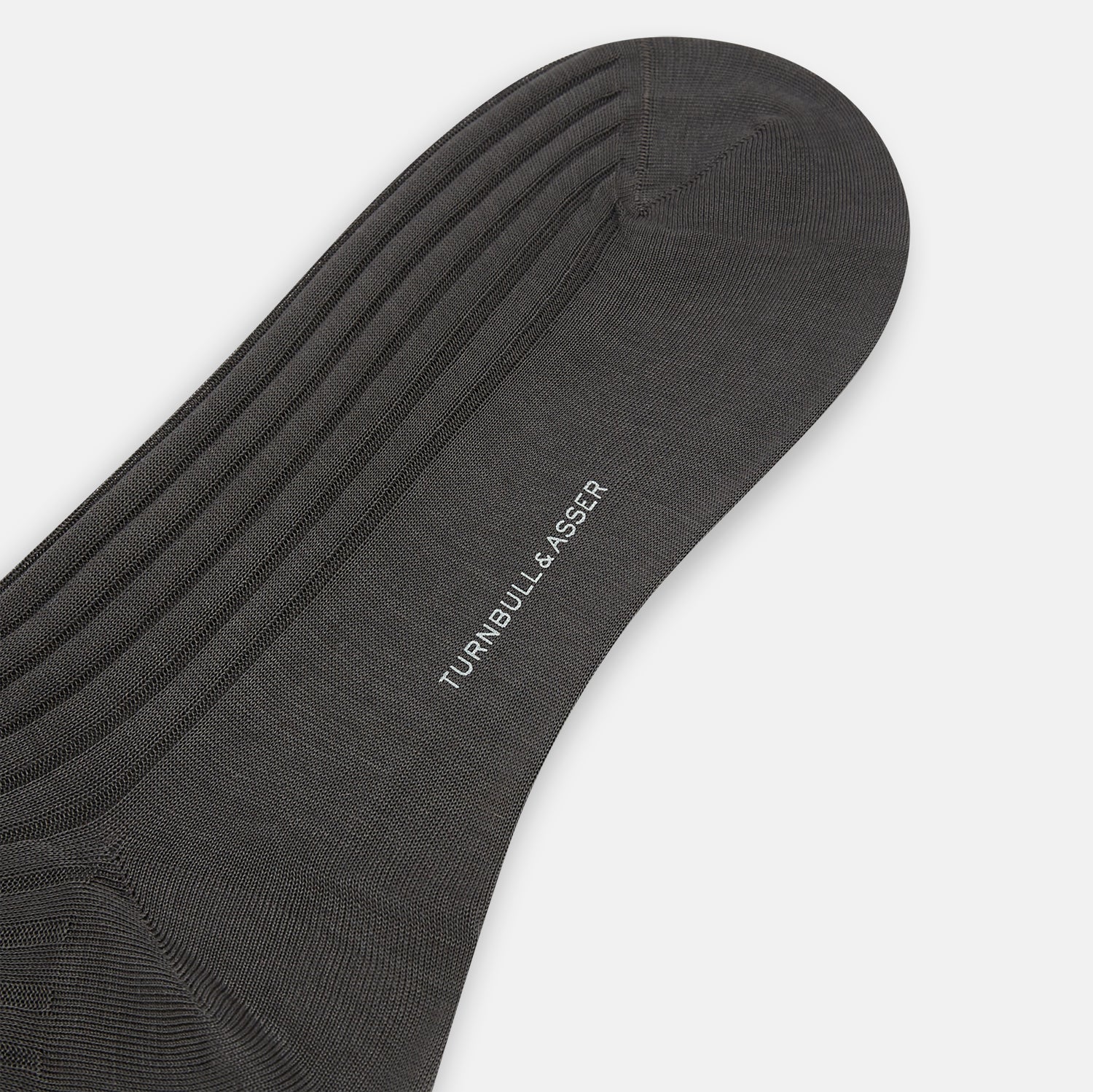 Image 3 of product A single Concrete Mid-Length Sock by Turnbull & Asser, crafted from mercerised Egyptian cotton for refined comfort, is shown upright on a white background with the toe pointing left and the cuff at the top.