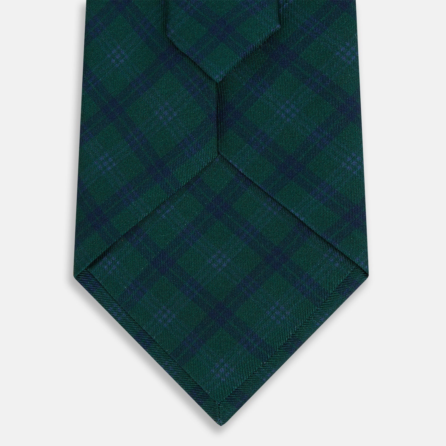 Image 3 of product The Turnbull & Asser Forest Melange Tartan Plaid Silk Tie features a classic green and blue plaid design, rolled up and displayed on a plain light background—reflecting timeless Scottish heritage.