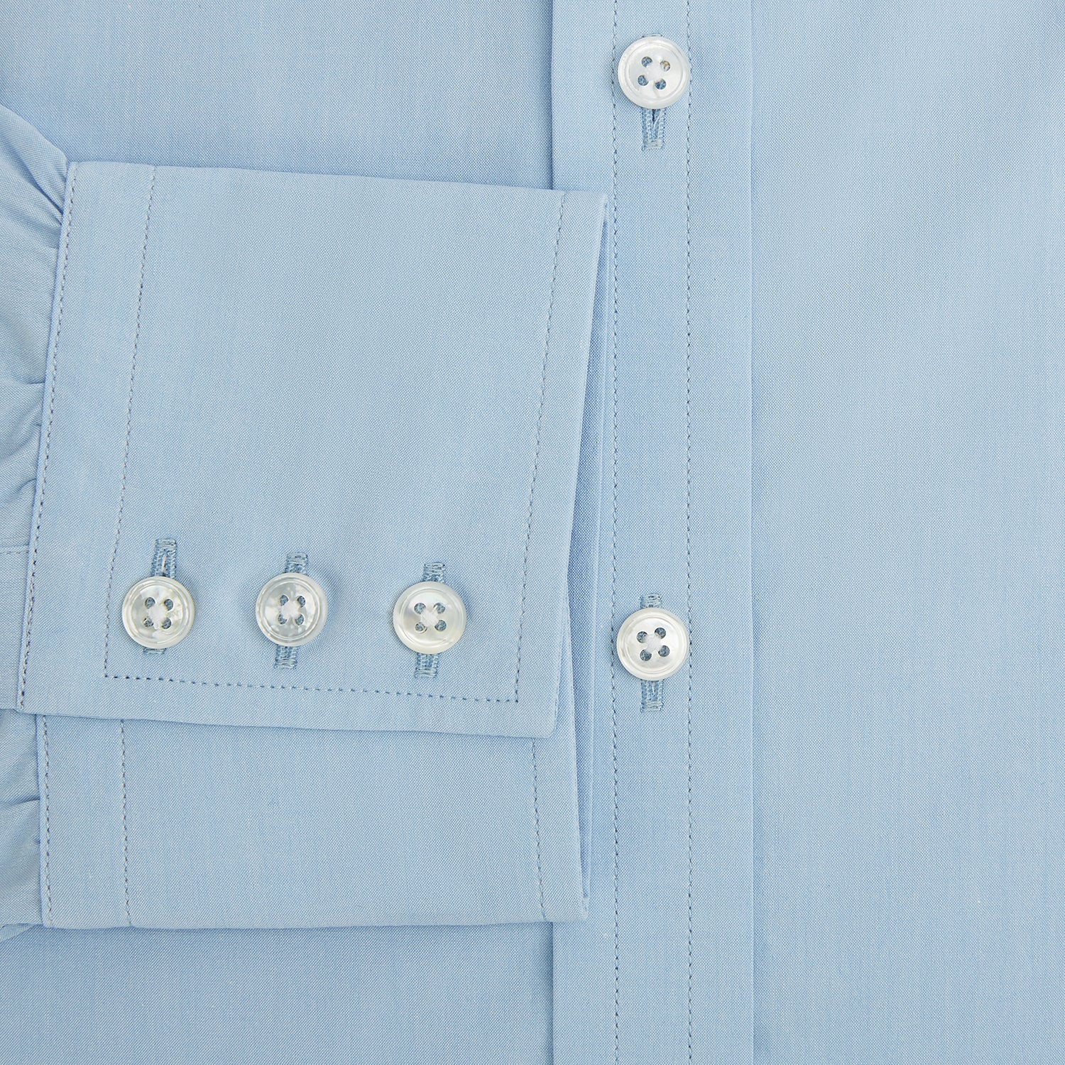 Image 4 of product The Turnbull & Asser Sky Blue Mayfair Shirt is a long-sleeved, collared button-down made from sanforised cotton, shown laid flat on a white background.