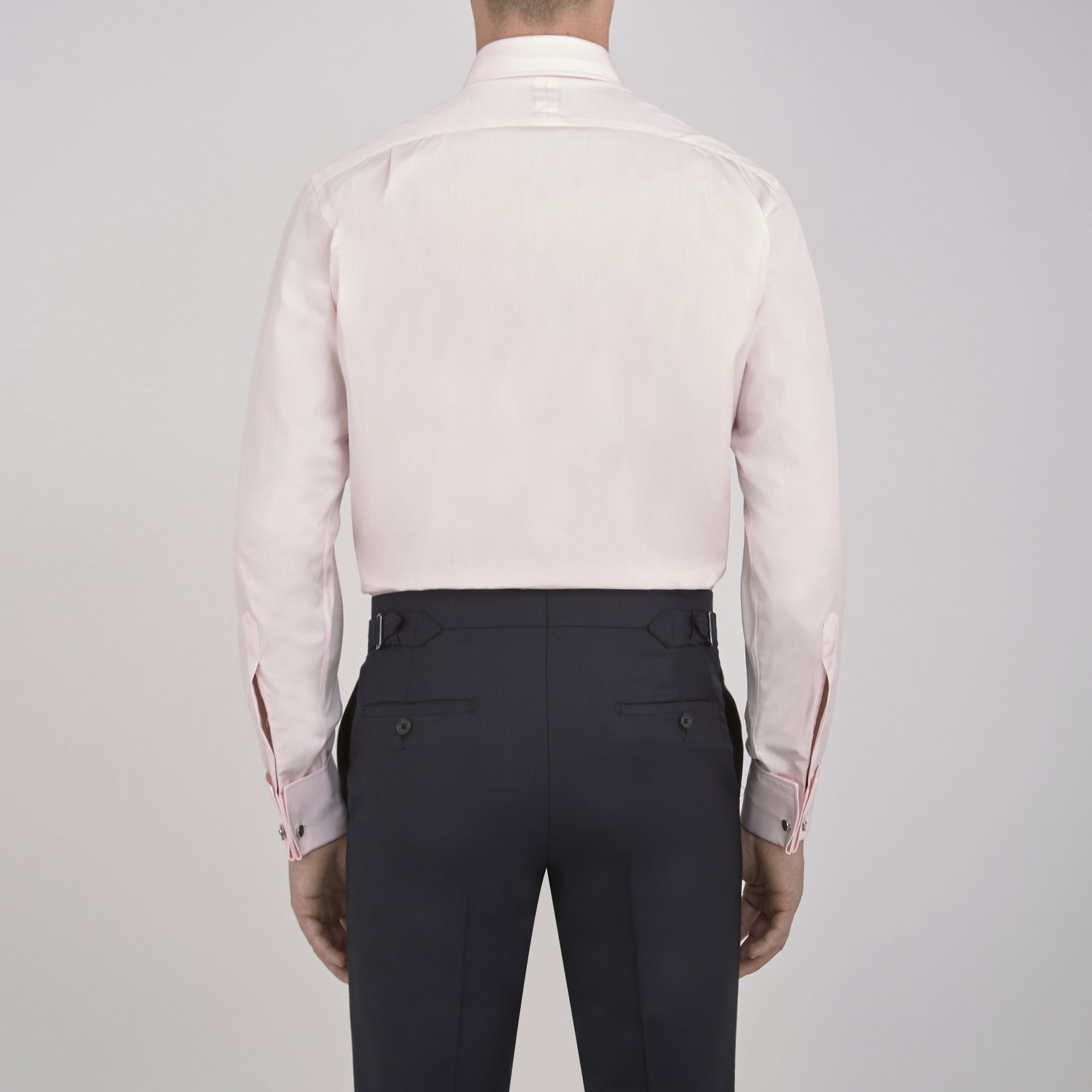 Image 5 of product A neatly folded Pink Cotton Shirt with T&A collar and double cuffs by Turnbull & Asser, featuring a classic design with white buttons and an inner label, displayed on a plain white background.