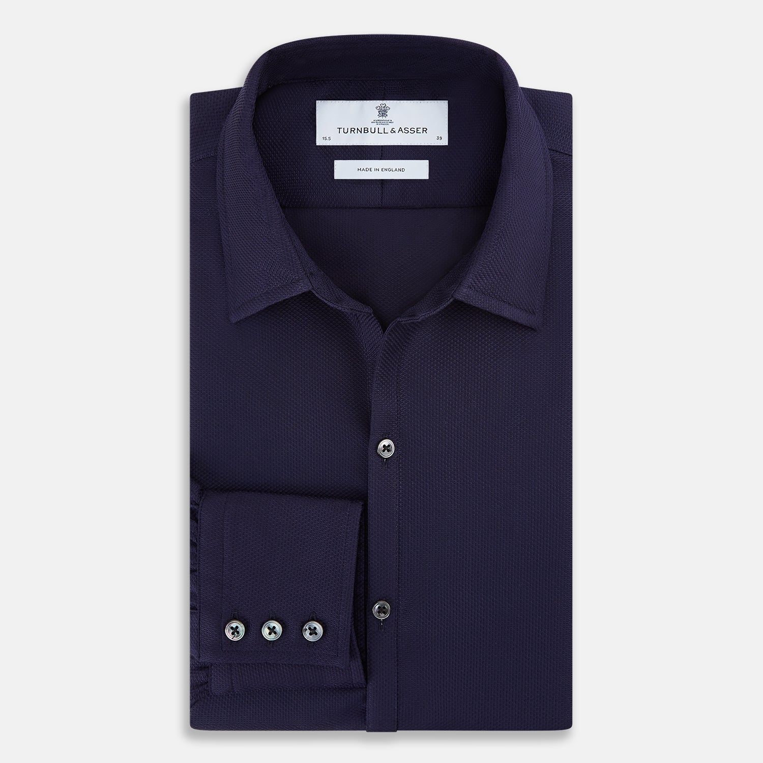 Image 5 of product The Navy Textured Windsor Shirt by Turnbull & Asser features long sleeves, a Windsor collar, buttoned cuffs, and white buttons—a fine example of British craftsmanship—set against a plain white background.