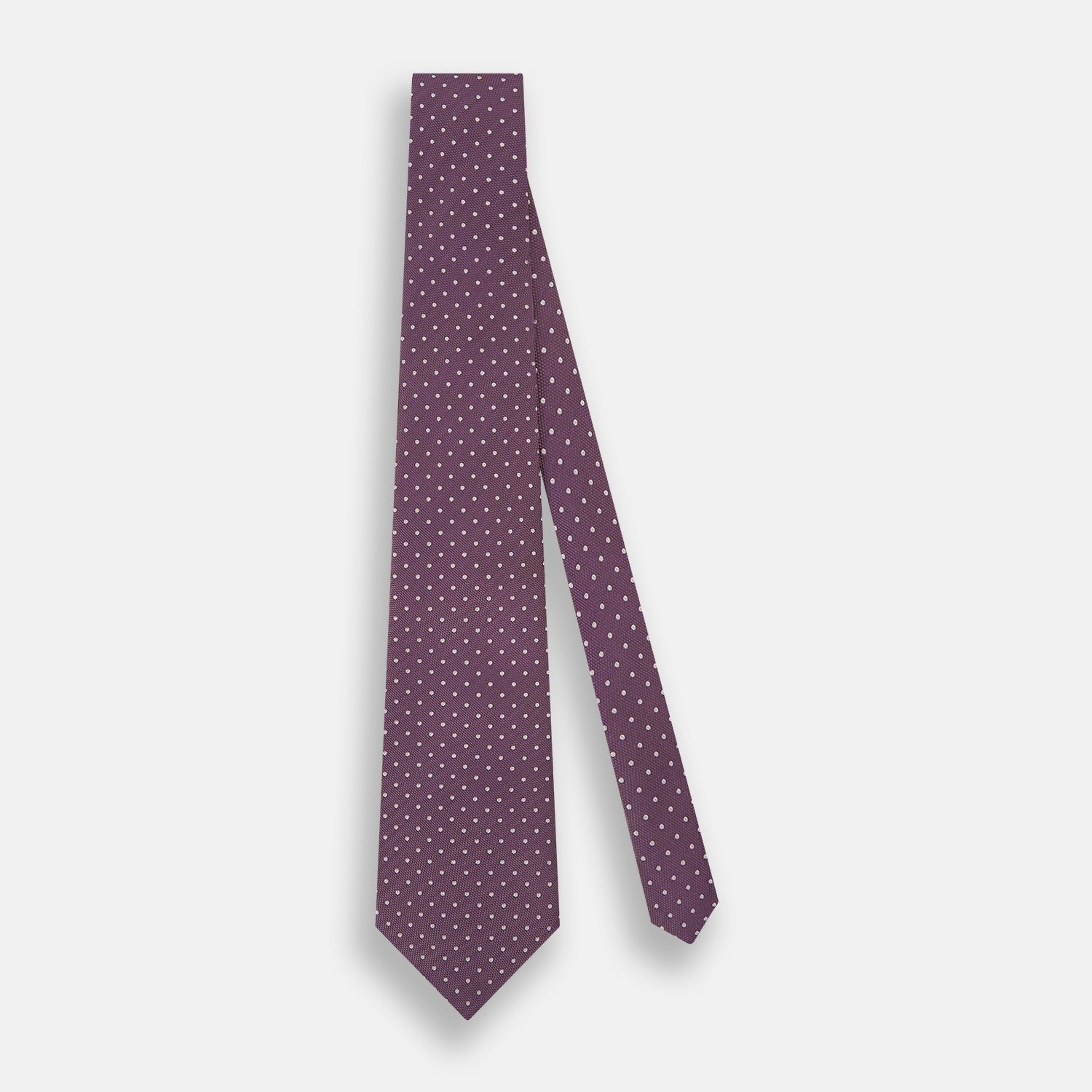 Image 2 of product The Turnbull & Asser Lilac and Purple Micro Dot Silk Tie, featuring small white dots, is a stylish accessory for smart attire. Displayed rolled-up on a light background.