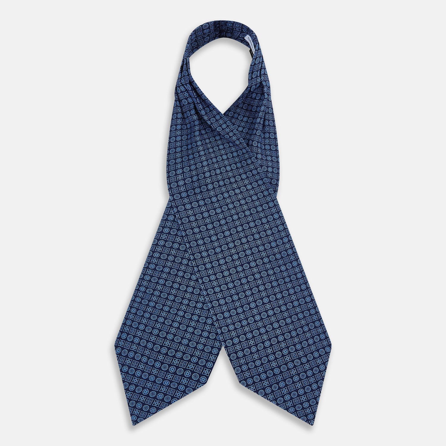 Image 2 of product The Turnbull & Asser Dark Navy Floral Tile Pattern Printed Silk Cravat features a British-inspired light blue floral tile design, elegantly displayed on a white background.