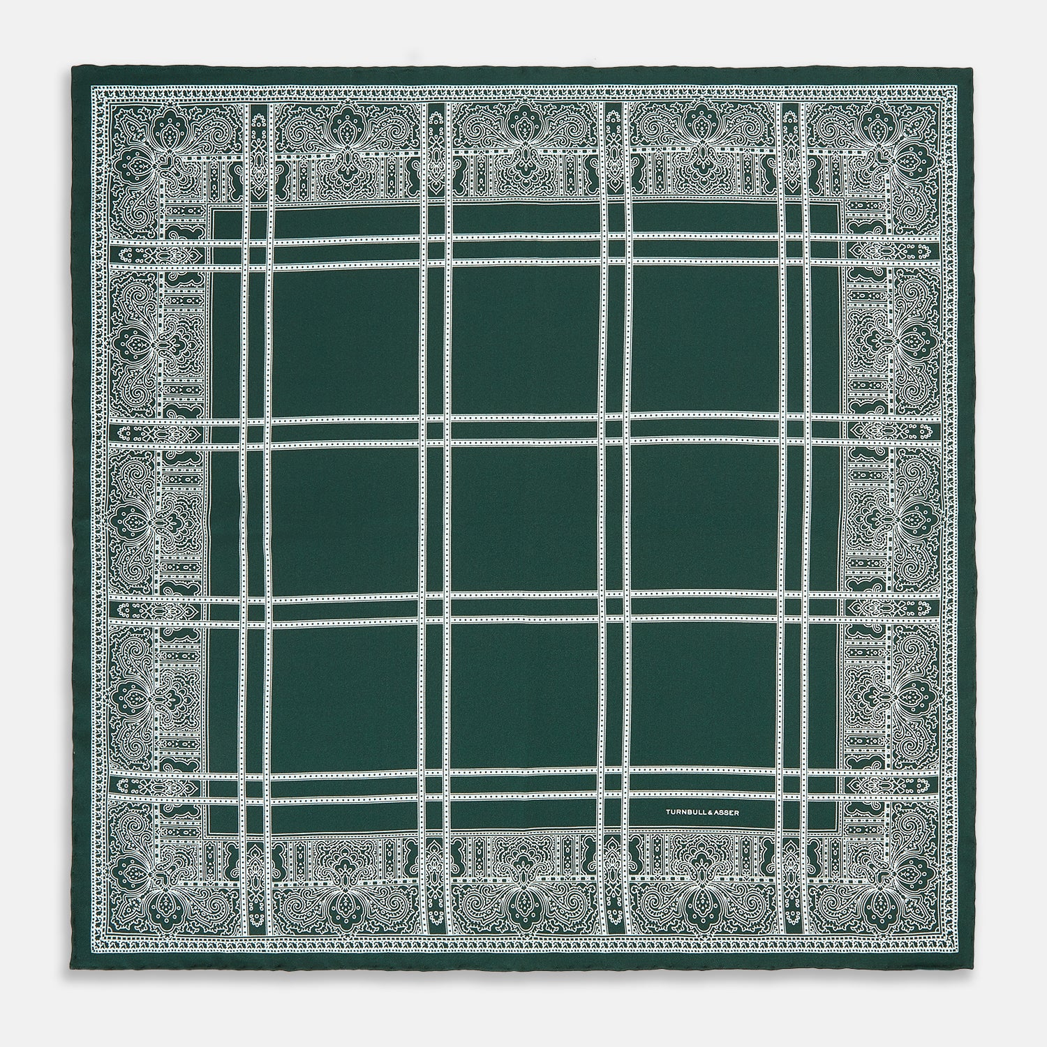 Image 4 of product Turnbull & Asser’s Forest Green Paisley Bandana Patterned Silk Pocket Square is handcrafted in England, featuring an intricate white geometric and paisley design with the brand name printed in one corner.