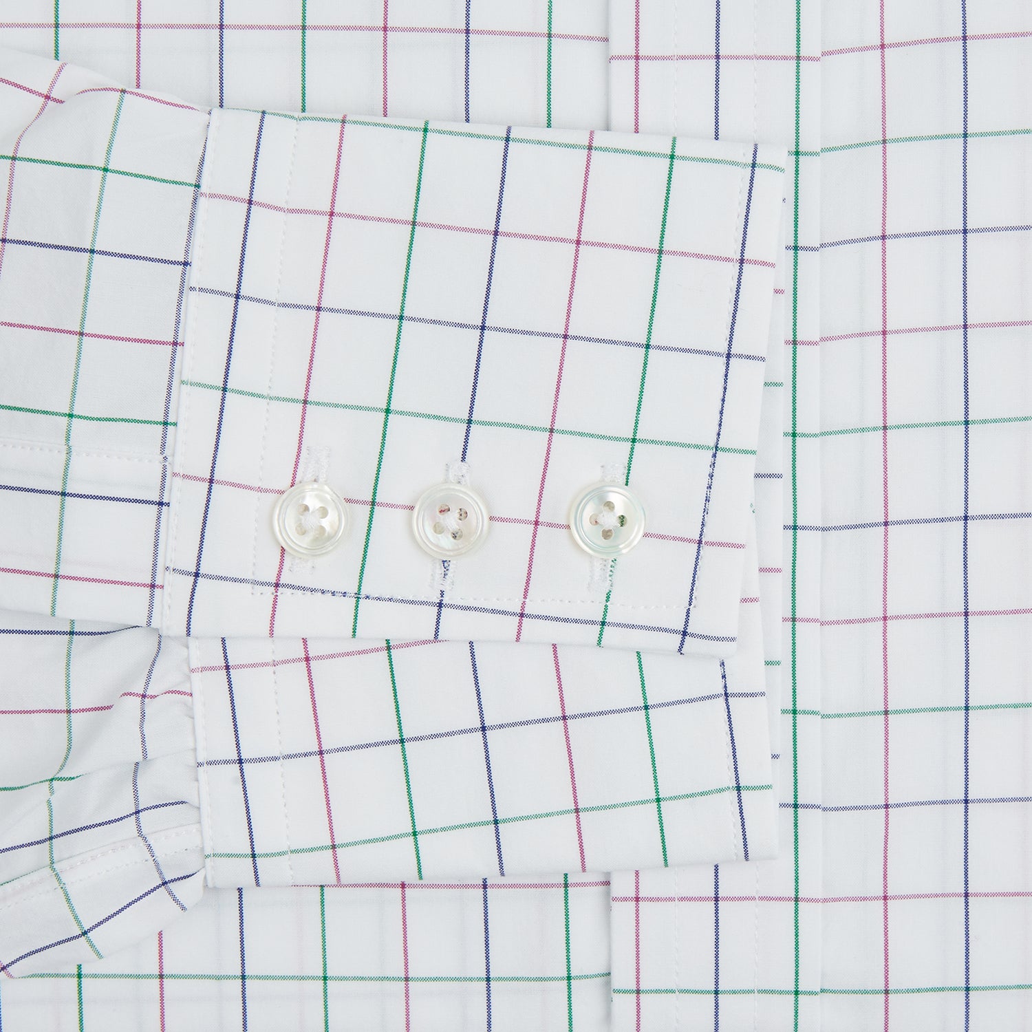 Image 3 of product The Turnbull & Asser Pink Grid Check Mayfair Shirt is a long-sleeve, button-down shirt with a T&A collar, crafted from organic cotton and featuring a pink checkered grid pattern on white with buttoned cuffs.