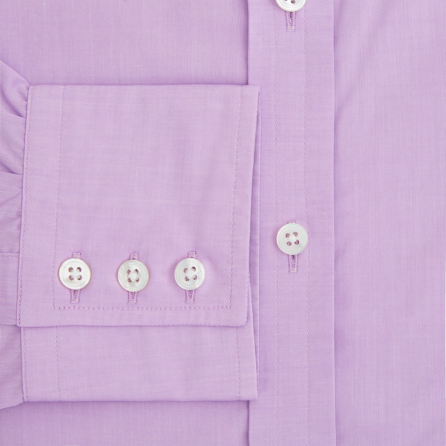 Image 4 of product The Turnbull & Asser Purple Pink Mayfair Shirt is a men's formal, long-sleeve button-up with a classic collar and buttoned cuffs, shown in light purple against a plain white background.