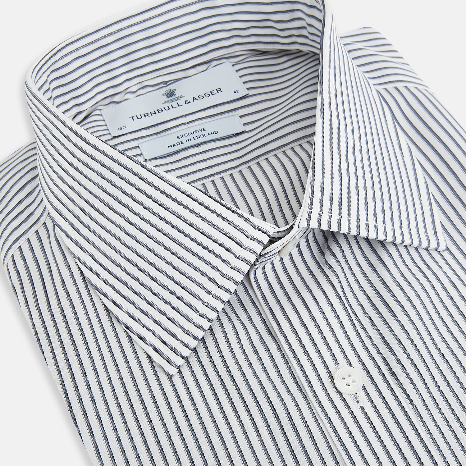 Image 2 of product The Turnbull & Asser Grey Multi Stripe Mayfair Shirt features long sleeves, a classic collar, and thin vertical stripes in black and white, shown laid flat on a white background.