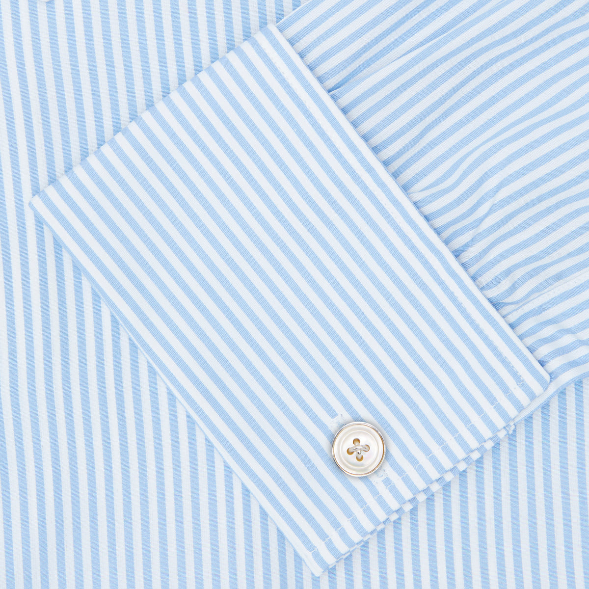 Image 3 of product The Turnbull & Asser Light Blue Bengal Stripe Shirt features a classic T&A collar, double cuffs, and white buttons. Made from cotton with blue and white stripes, it's neatly displayed against a plain white background.