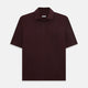 The Turnbull & Asser Burgundy Polo Shirt is crafted from soft cotton jersey with short sleeves, a classic collar, three front buttons, and a small buttoned chest pocket, shown flat on a white background.