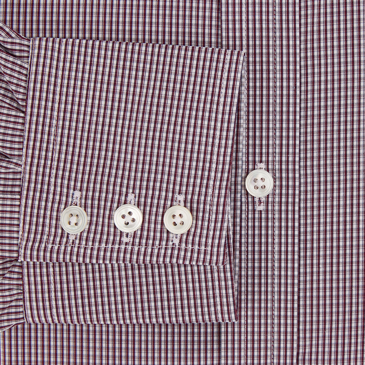 Image 4 of product The Turnbull & Asser Burgundy Micro Check Mayfair Shirt features long sleeves, a pointed collar, and white buttons—perfect for formal wear. Shown laid flat on a white background.