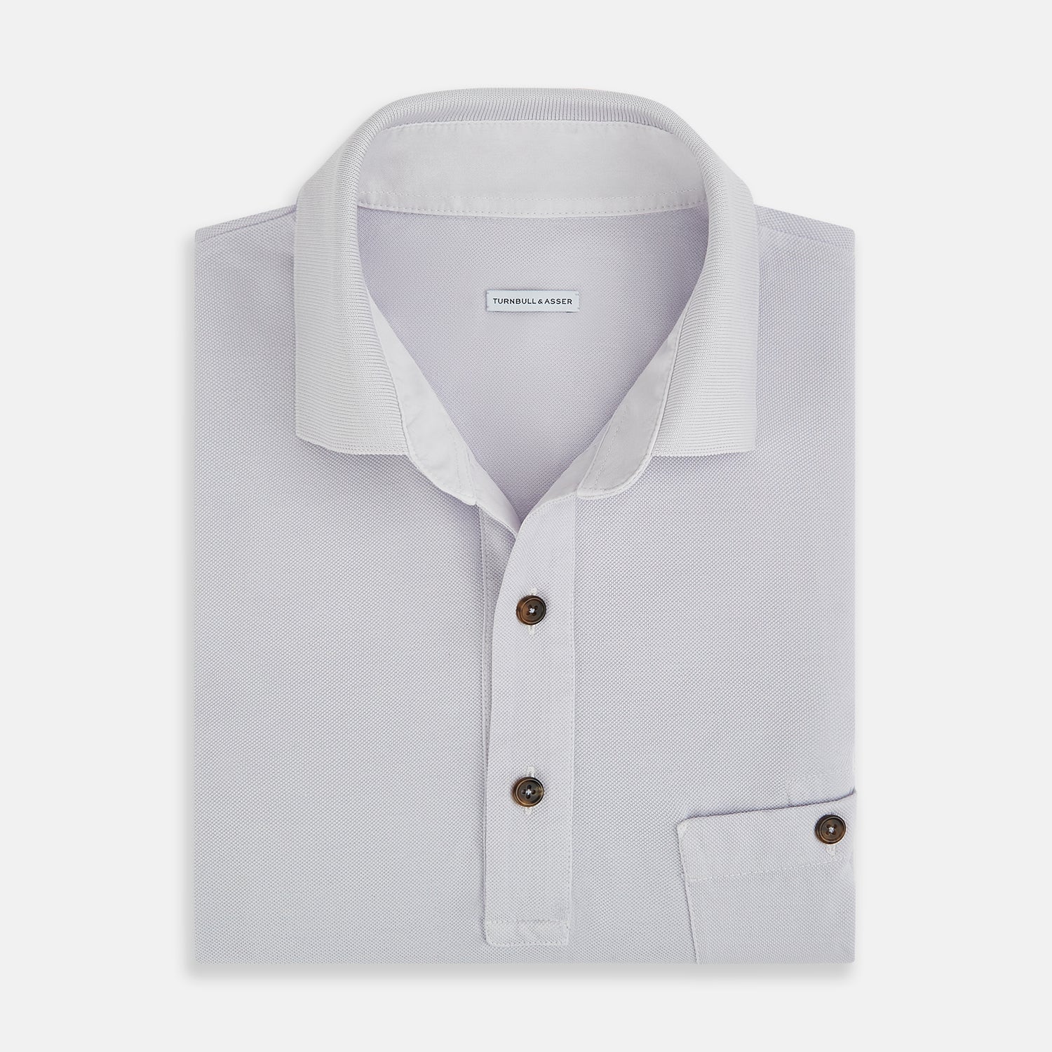 Image 4 of product A soft pink cotton polo shirt by Turnbull & Asser features short sleeves, a contrasting white collar, three dark buttons, and a left chest pocket. Laid flat on a white background—it’s perfect for modern men’s fashion.