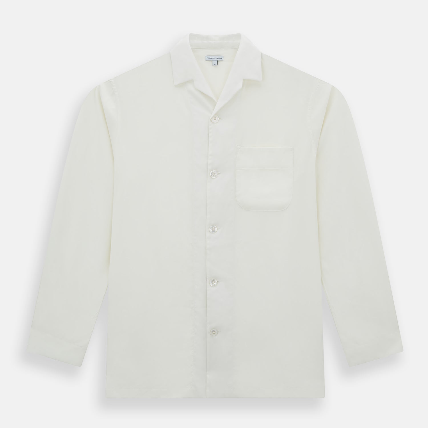Image 4 of product The Turnbull & Asser Cream Silk Pyjama Set, shown laid flat on a white background, features a long-sleeve button-up top with a chest pocket and matching pants with an elastic drawstring waist—ideal for comfortable loungewear.