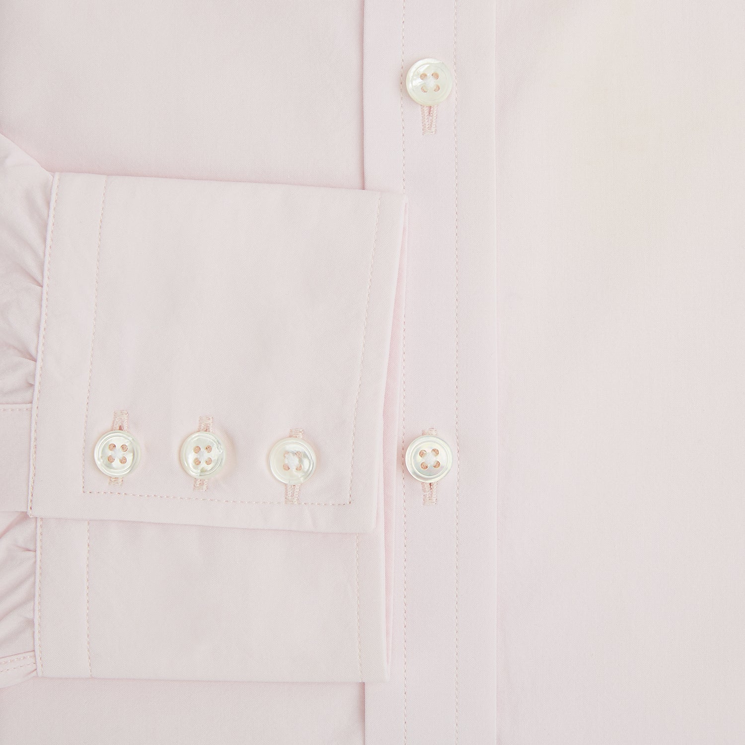 Image 4 of product The Soft Pink Mayfair Shirt by Turnbull & Asser is a long-sleeved, sanforised cotton button-up with a classic collar, white buttons, and buttoned cuffs, shown against a plain white background.