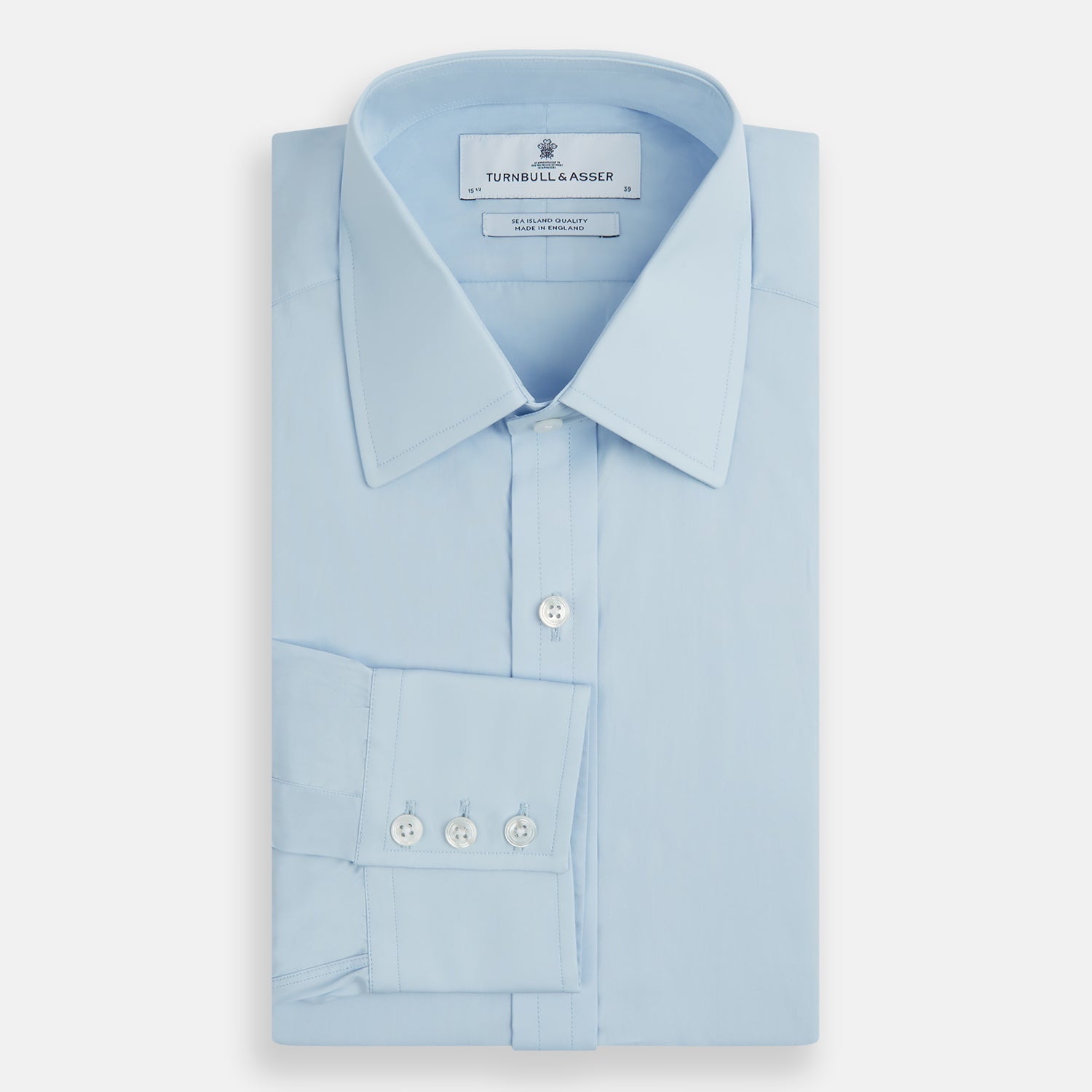 Image 5 of product The Turnbull & Asser Light Blue Sea Island Quality Cotton Shirt features a T&A collar, 3-button cuffs, and premium cotton fabric, shown laid flat against a white background.