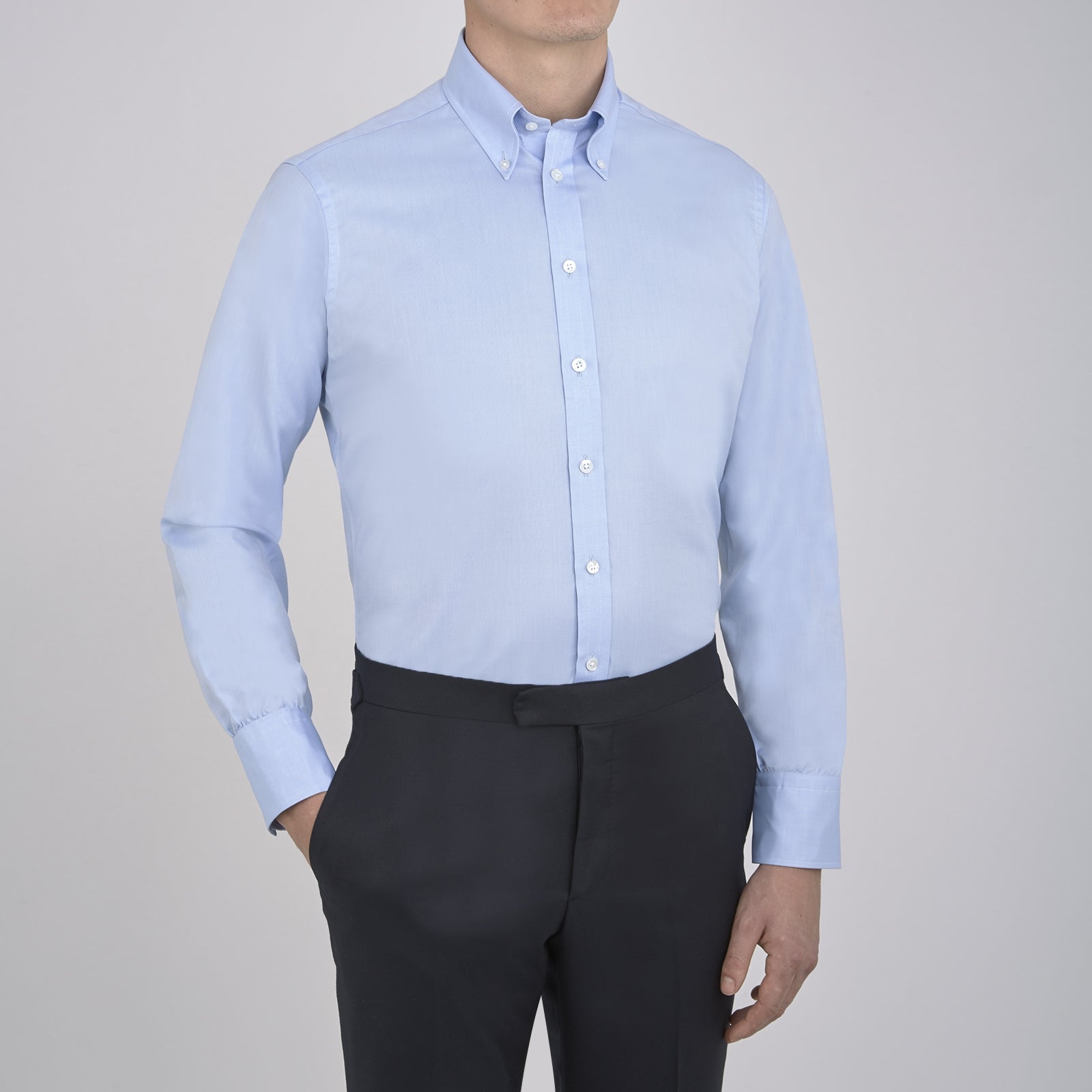Image 4 of product The Turnbull & Asser Light Blue Royal Oxford Cotton Shirt features a button-down collar, 3-button cuffs, and white buttons. Neatly folded with a visible inner label, it’s ideal to pair with a navy suit and displayed on a plain white background.