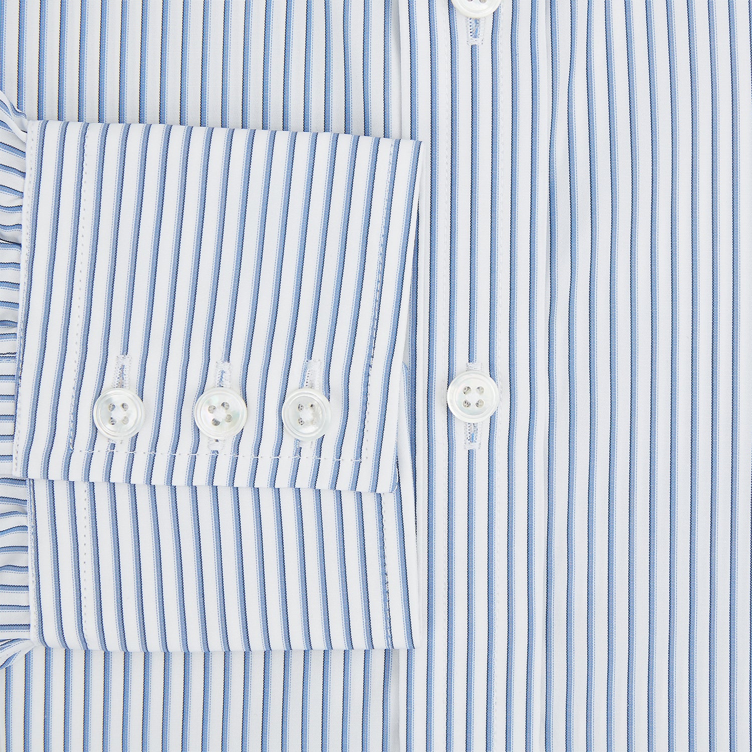 Image 4 of product The Turnbull & Asser Blue Shadow Stripe Mayfair Shirt is a long-sleeve button-up with a T&A collar and thin blue vertical stripes on white, shown on a plain white background.