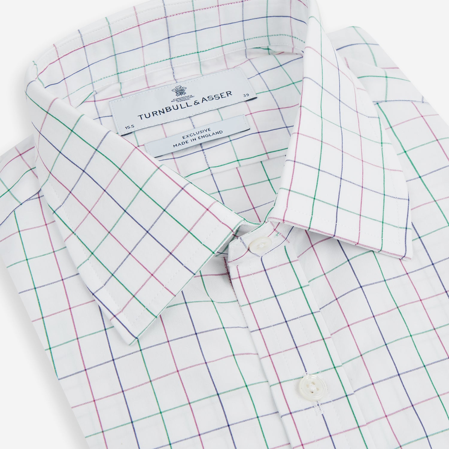 Image 2 of product The Turnbull & Asser Pink Grid Check Mayfair Shirt is a long-sleeve, button-down shirt with a T&A collar, crafted from organic cotton and featuring a pink checkered grid pattern on white with buttoned cuffs.