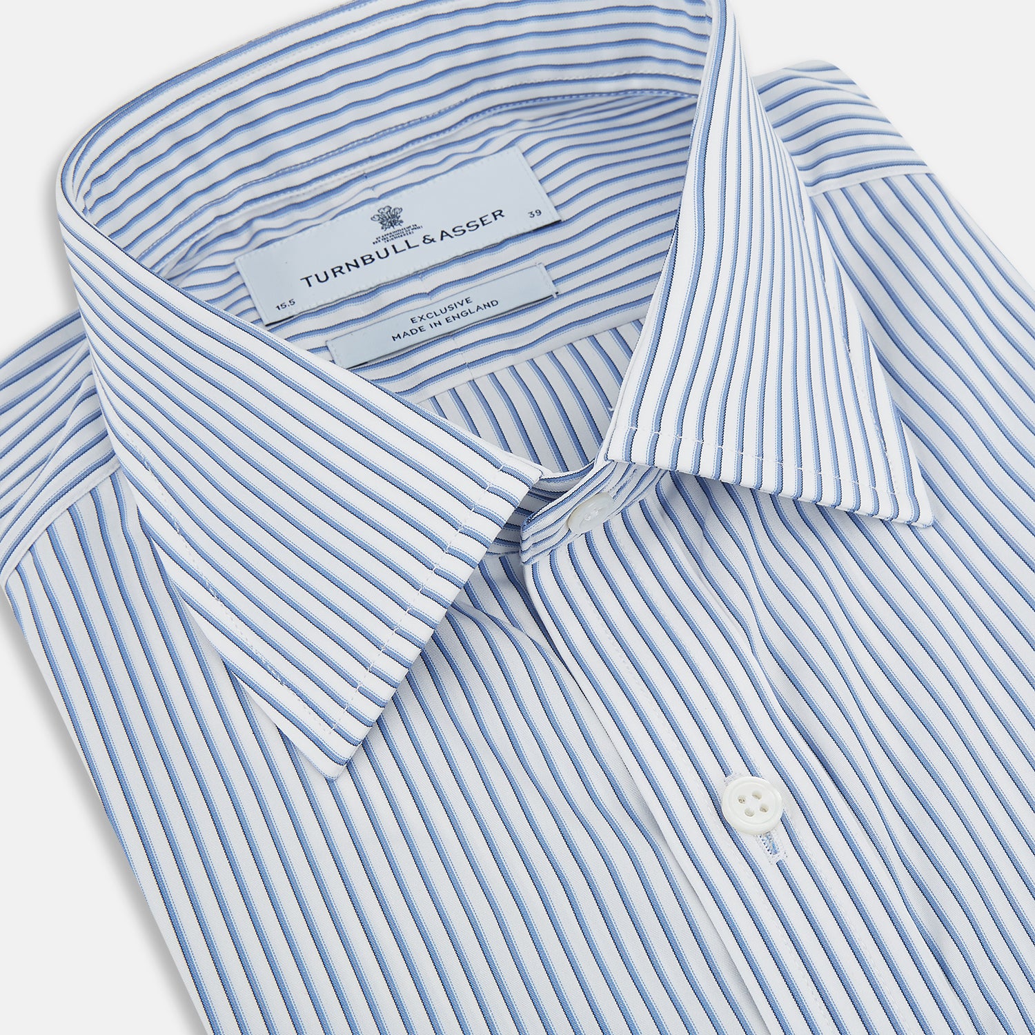 Image 2 of product The Turnbull & Asser Blue Shadow Stripe Mayfair Shirt is a long-sleeve button-up with a T&A collar and thin blue vertical stripes on white, shown on a plain white background.