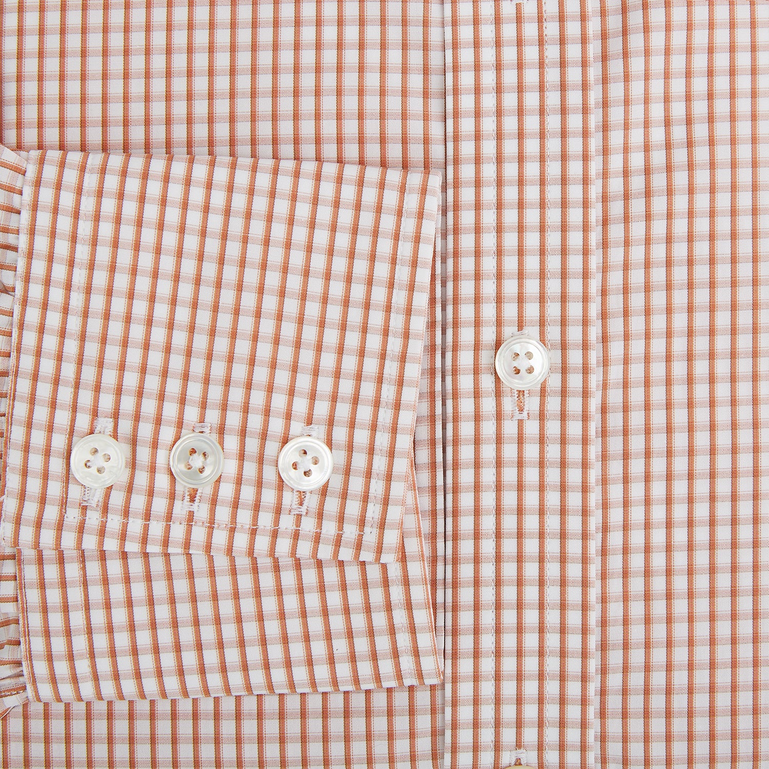 Image 4 of product The Orange Micro Shadow Check Mayfair Shirt by Turnbull & Asser features a T&A collar, button-down front, and buttoned cuffs; crafted from Italian cotton in an orange and white check pattern, laid flat on a white background.