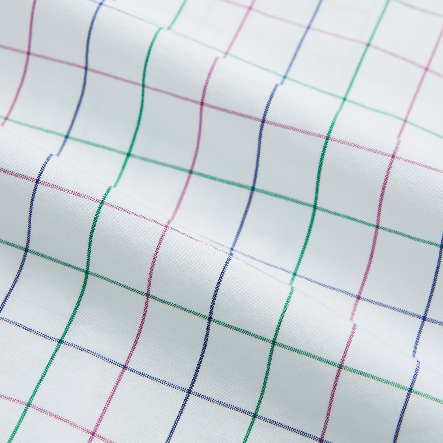Image 6 of product The Turnbull & Asser Pink Grid Check Mayfair Shirt is a long-sleeve, button-down shirt with a T&A collar, crafted from organic cotton and featuring a pink checkered grid pattern on white with buttoned cuffs.