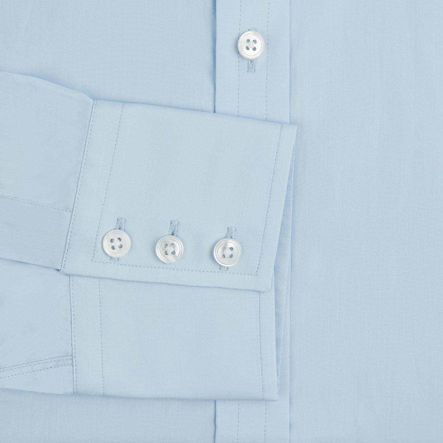 Image 4 of product The Turnbull & Asser Light Blue Sea Island Quality Cotton Shirt features a T&A collar, 3-button cuffs, and premium cotton fabric, shown laid flat against a white background.