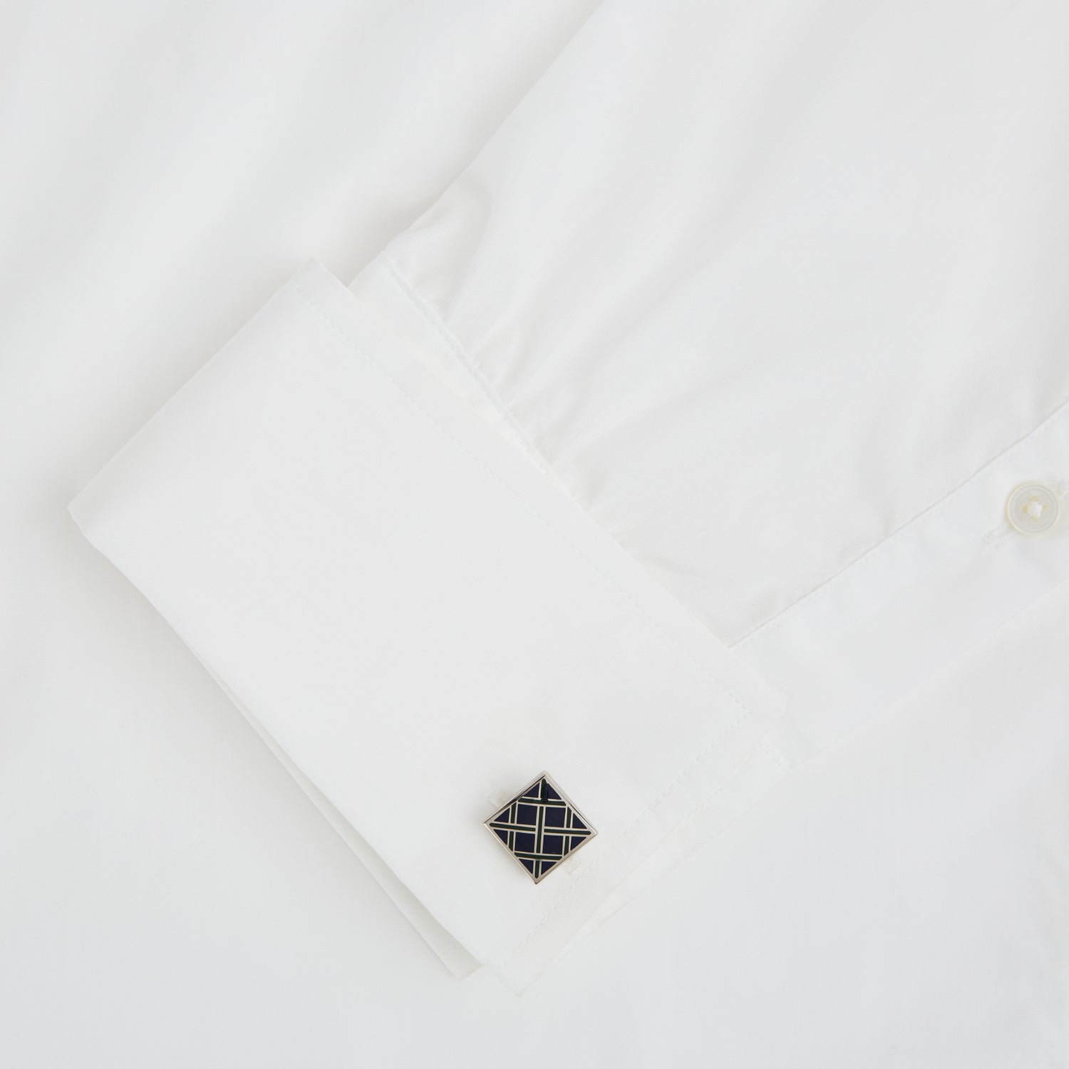 Image 3 of product The Blue Grid Square Cufflinks by Turnbull & Asser feature a geometric square sterling silver design with intersecting navy, black, and white lines, showcased on a white background.