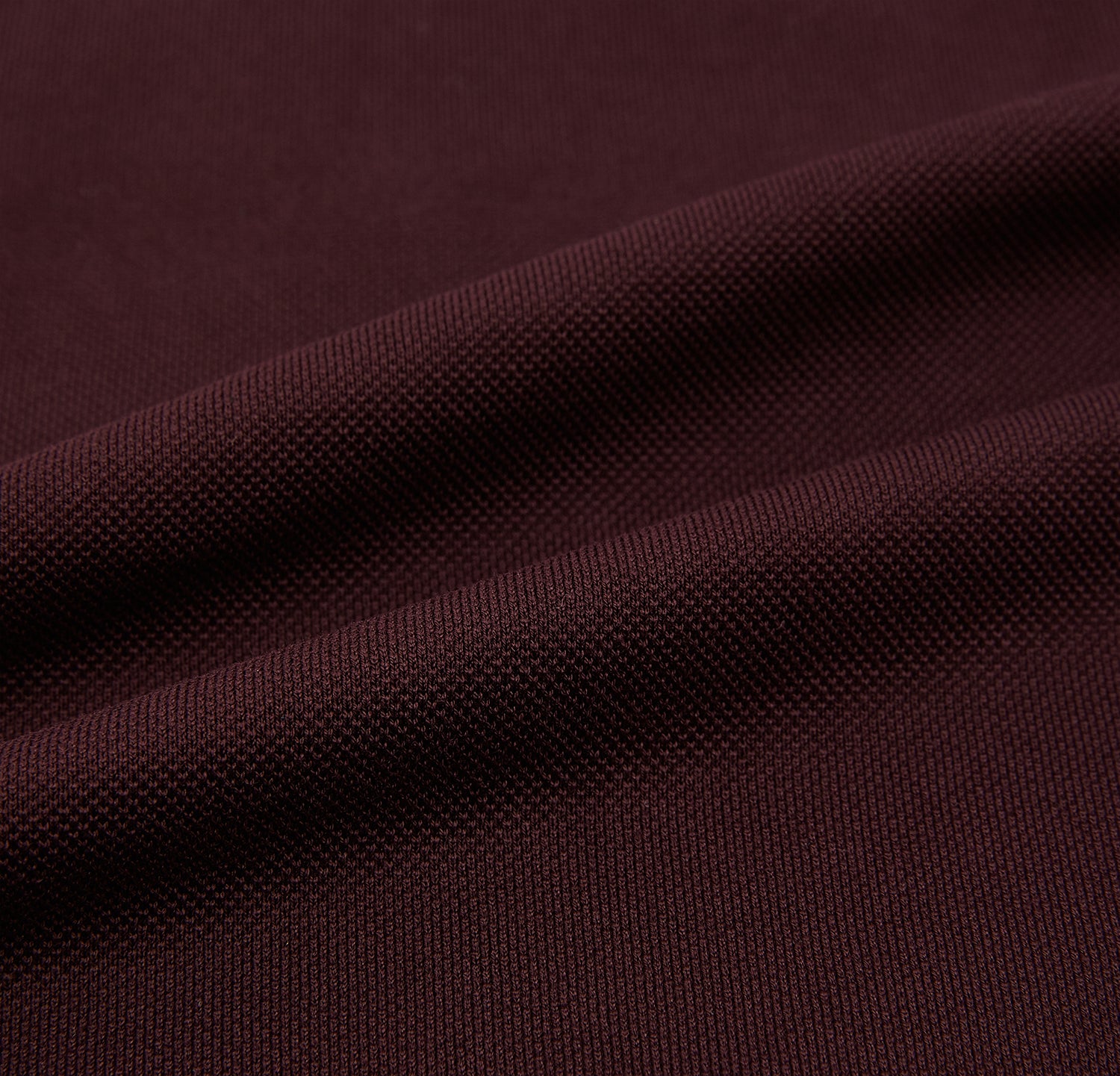 Image 5 of product The Turnbull & Asser Burgundy Polo Shirt is crafted from soft cotton jersey with short sleeves, a classic collar, three front buttons, and a small buttoned chest pocket, shown flat on a white background.