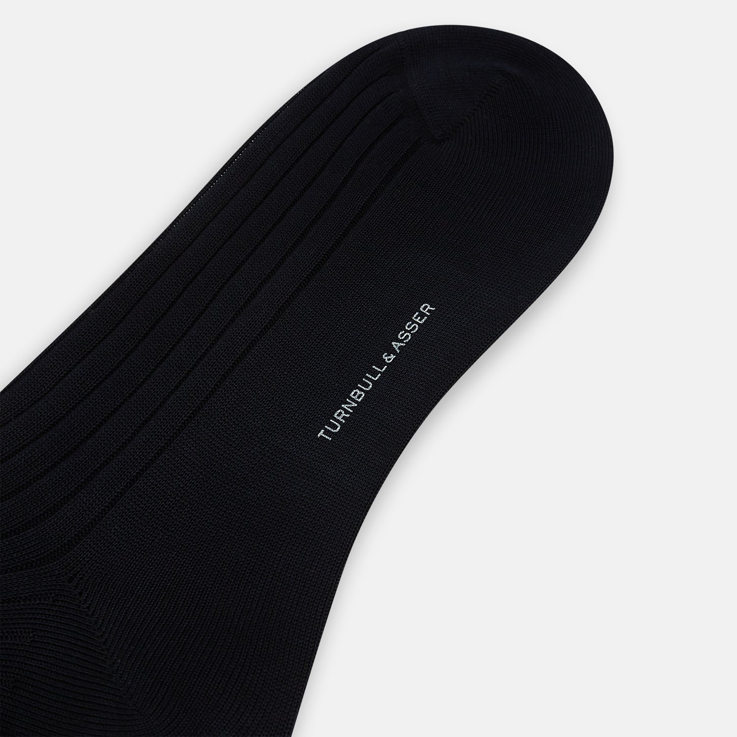 Image 3 of product A single Midnight Thick Knit Mid-Length Sock by Turnbull & Asser, crafted from black mercerised Egyptian cotton, is shown in side profile against a plain white background with the toe pointing left.
