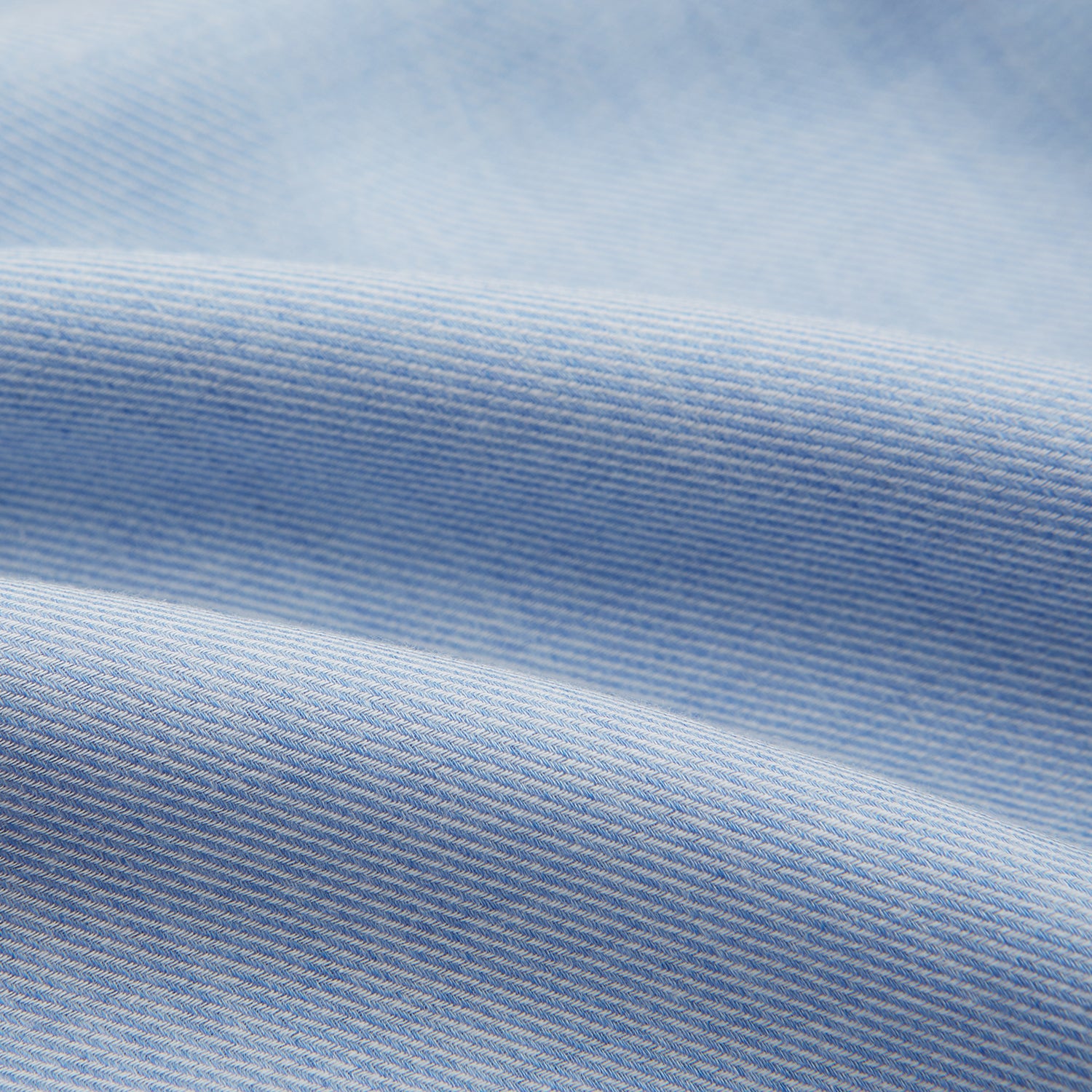 Image 5 of product The Turnbull & Asser Pale Blue Cotton Cashmere Derby Collar Richmond Shirt features a soft cotton-cashmere blend, derby collar, white buttons, left chest pocket, and buttoned cuffs, shown laid flat on a white background.