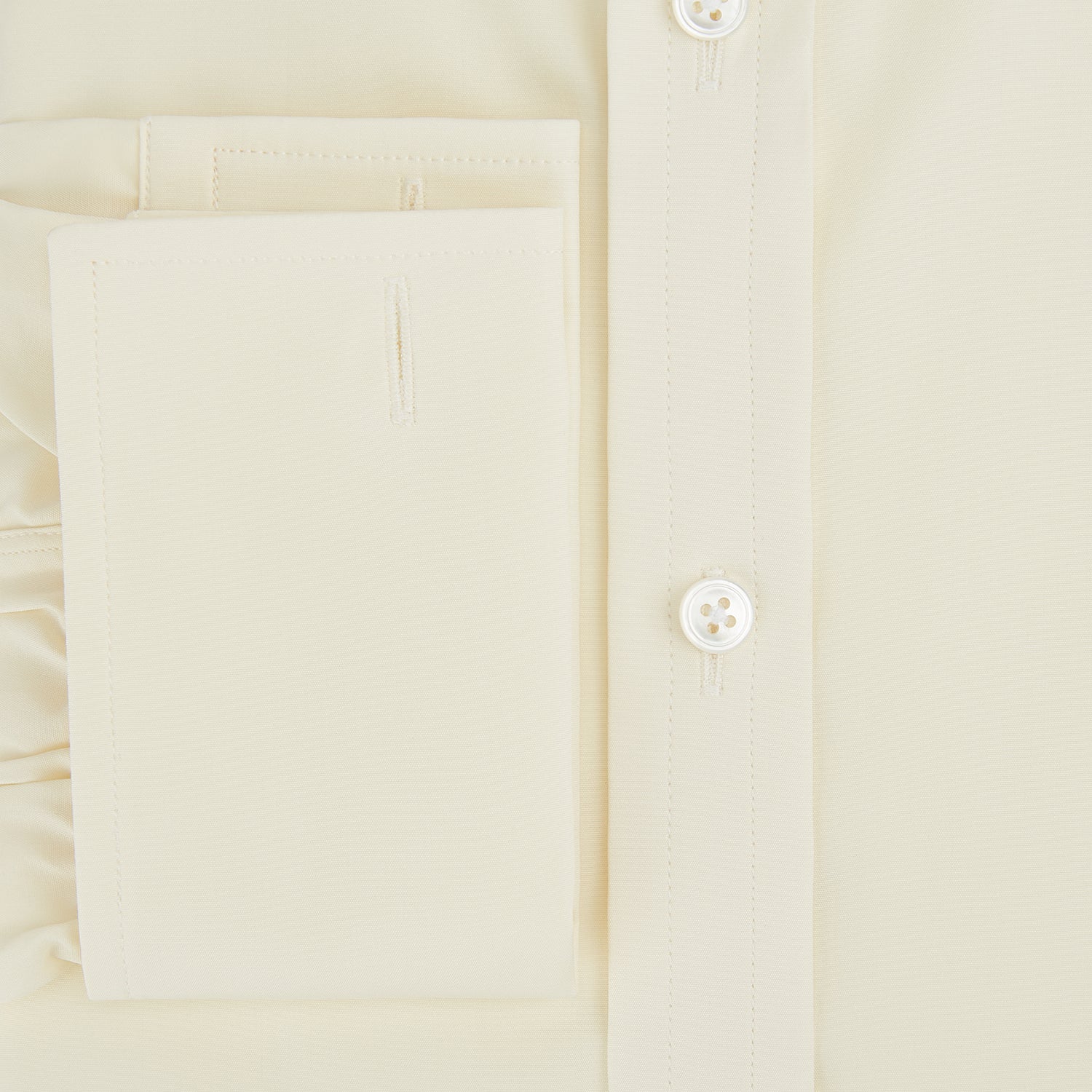 Image 4 of product The Turnbull & Asser Cream Cotton Shirt features a T&A collar and double cuffs, elevating men's style. Displayed flat against a white background, this long-sleeve shirt is crafted in classic cream cotton.