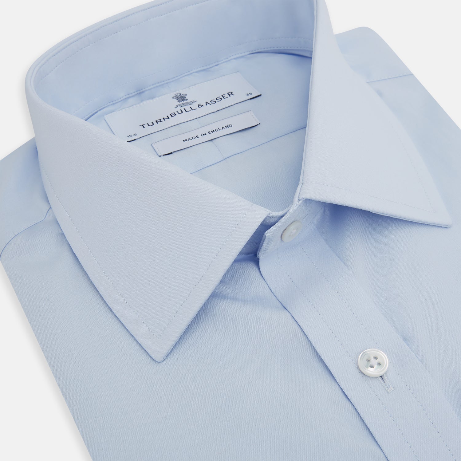 Image 2 of product The Turnbull & Asser Light Blue Mayfair Shirt features white buttons, a classic collar, and buttoned cuffs—styled flat on a white background, it’s ideal for minimalist outfits or pairing with bold ties.