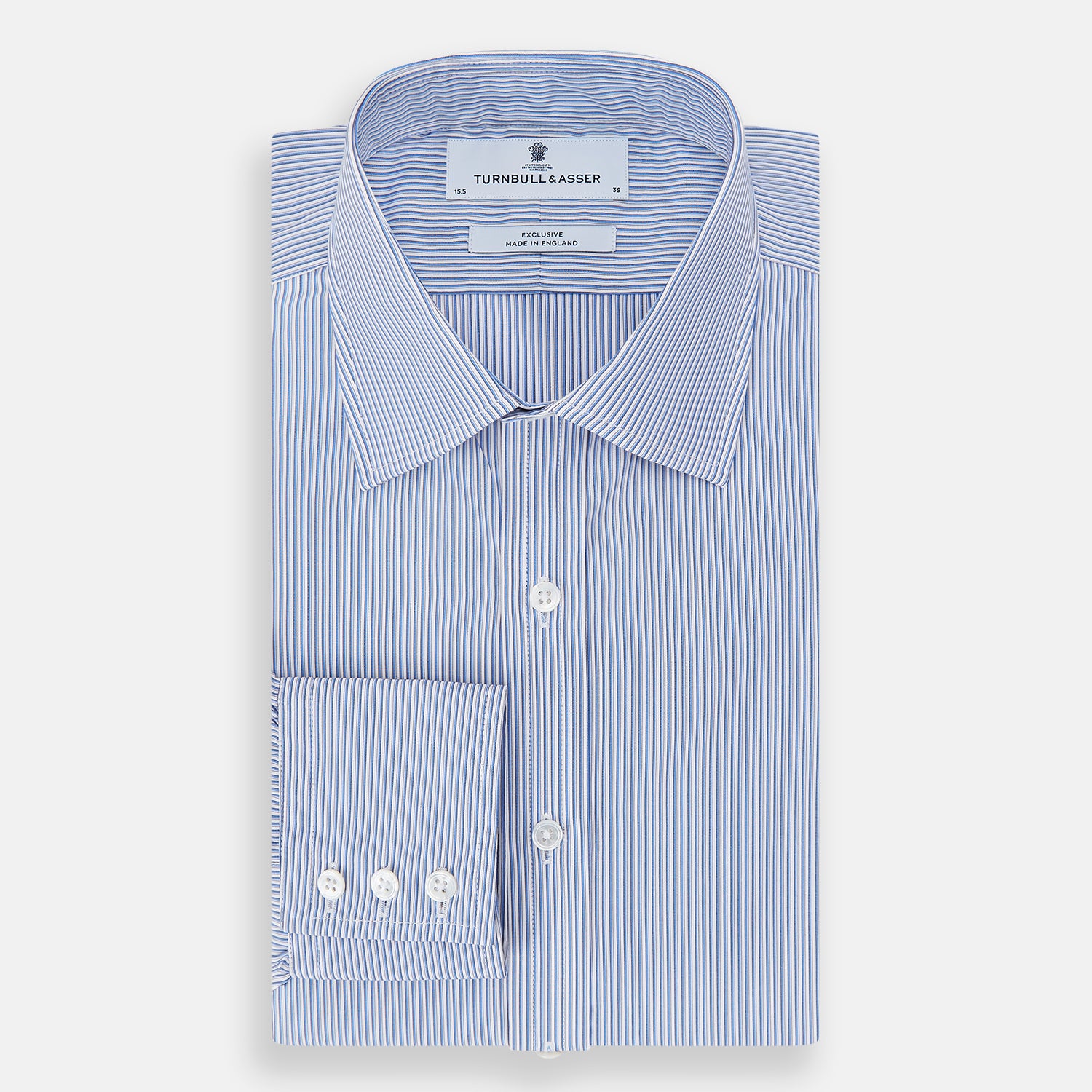 Image 5 of product The Turnbull & Asser Pale Blue Pinstripe Mayfair Shirt features pale blue pinstripes, a classic T&A collar, white buttons, and cuffed sleeves, shown against a plain white background.