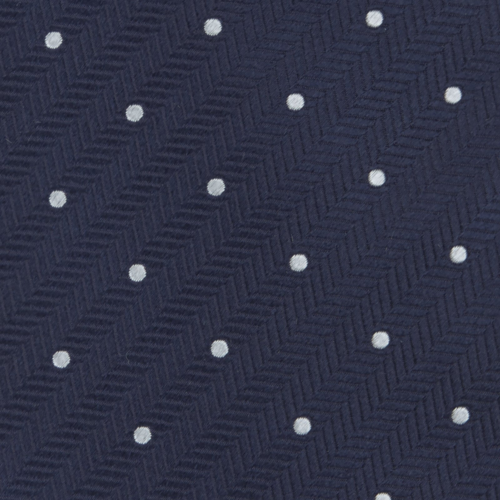 Image 3 of product The Navy and White Small Spot Herringbone Silk Tie from Turnbull & Asser features a classic navy herringbone pattern with small white polka dots, offering an elegant look suitable for any occasion.