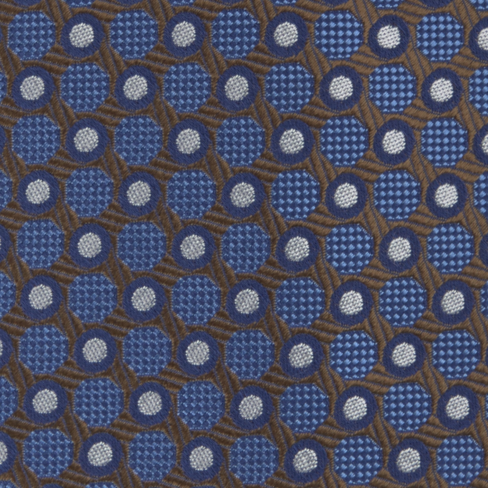 Image 3 of product The Turnbull & Asser Brown and Blue Circle and Spot Silk Tie features a repeating pattern of brown and blue spots, ideal for office wear, shown on a white background.