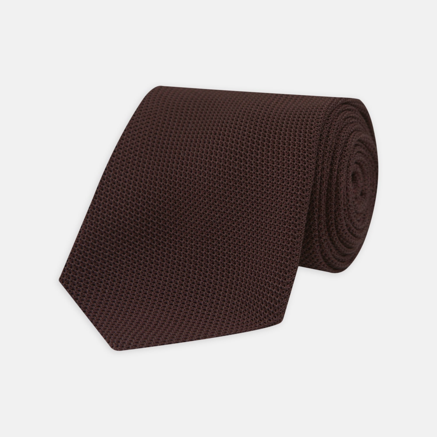 Image 1 of product The Turnbull & Asser Burgundy Grenadine Silk Tie, featuring a textured grenadine weave, is rolled up and displayed against a plain white background.