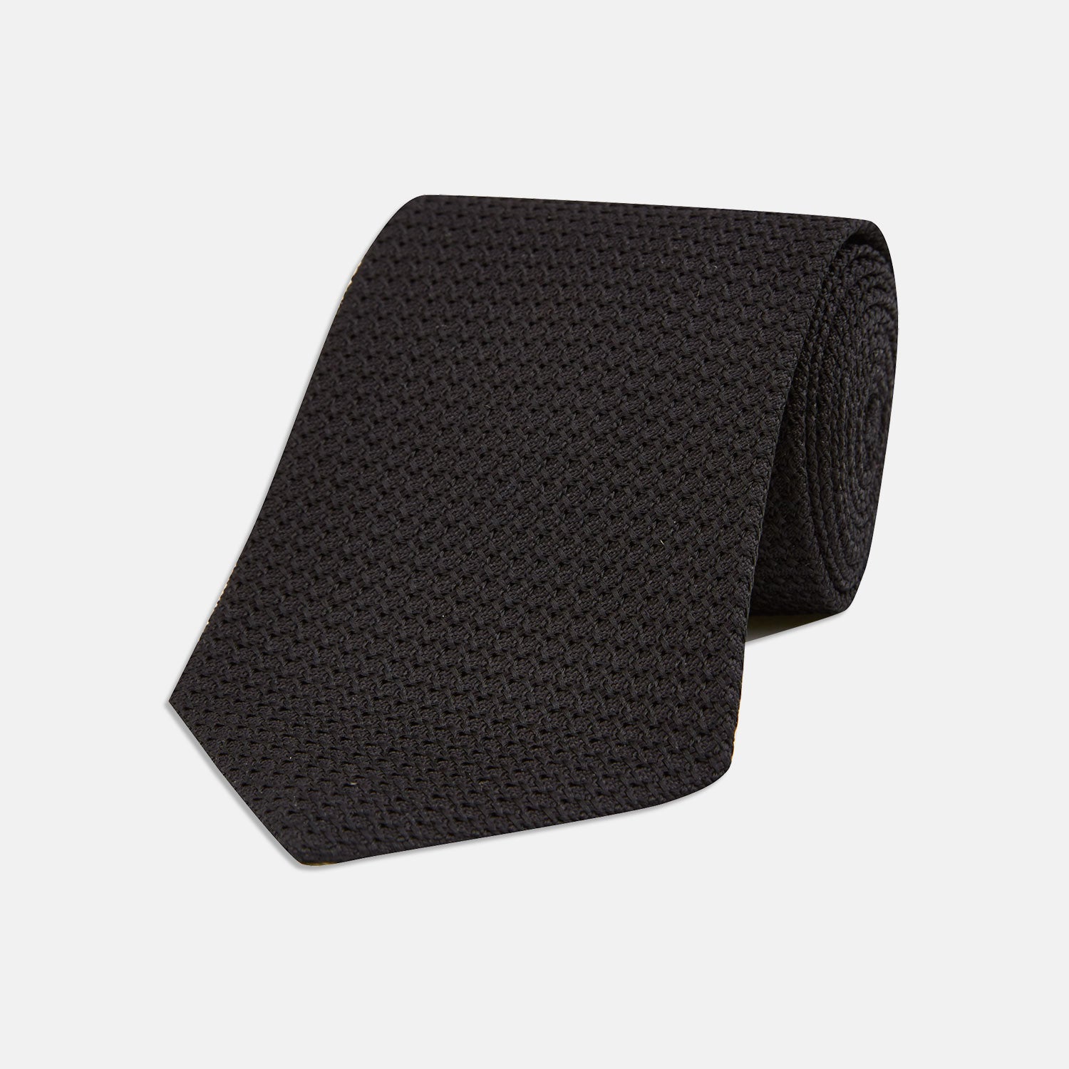 Image 1 of product The Turnbull & Asser Black Grenadine Silk Tie features a refined textured look and dimensional stability thanks to its subtle grenadine weave, shown here on a white background.