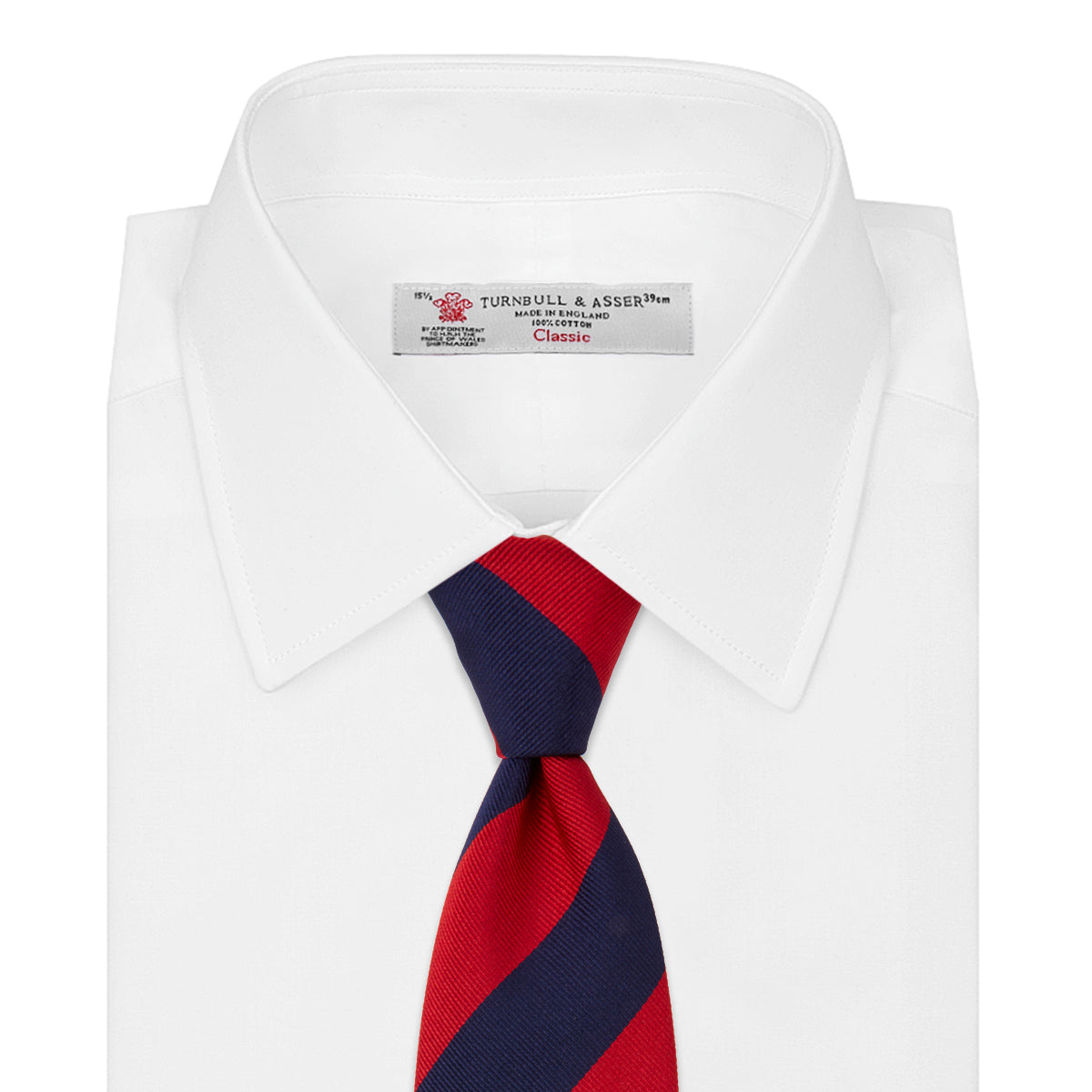 Image 2 of product The Navy and Red Block Stripe Repp Silk Tie by Turnbull & Asser features bold diagonal red and navy stripes on a crisp white background.