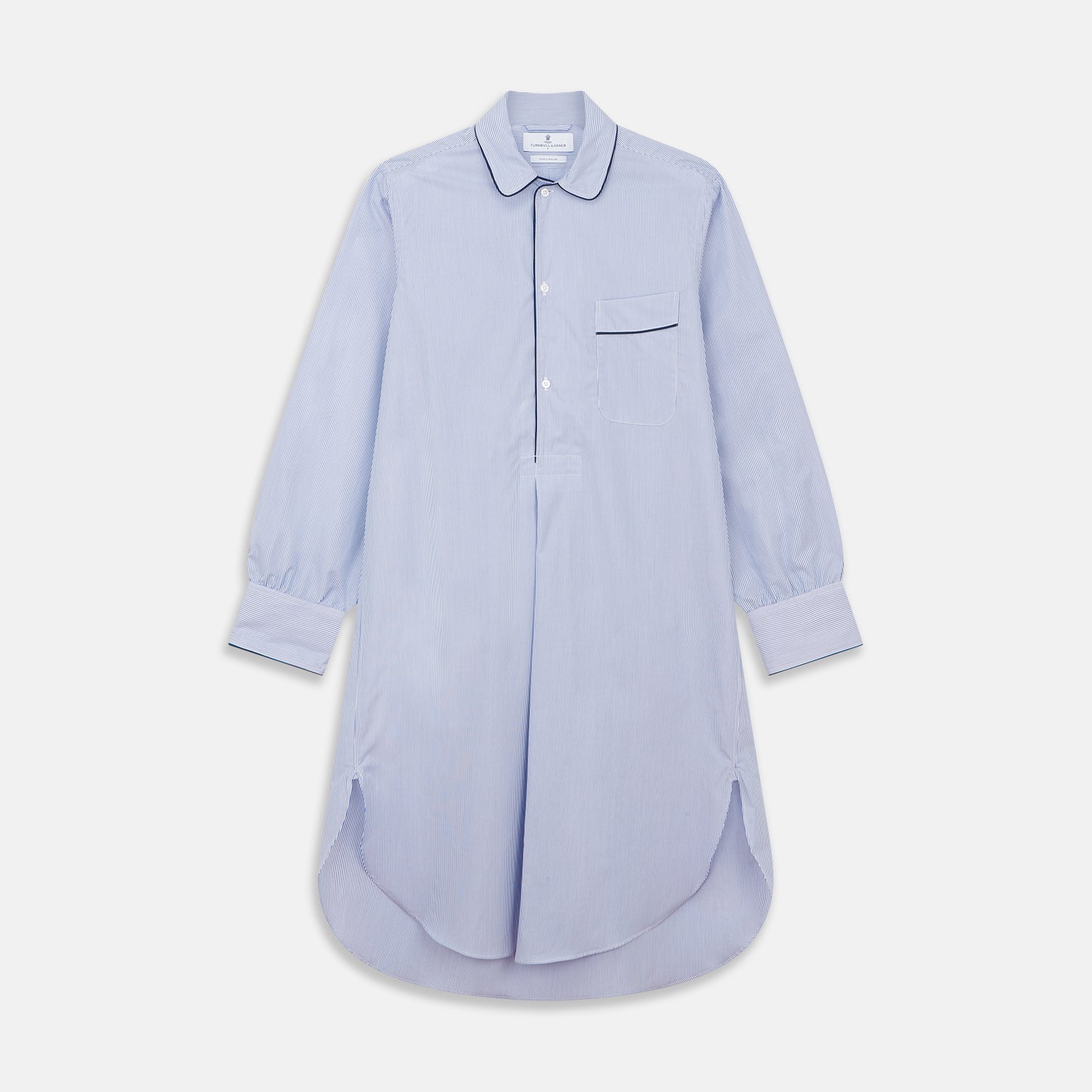 Image 1 of product The Turnbull & Asser Blue Fine Bengal Stripe Piped Cotton Nightshirt features long sleeves, a chest pocket, black collar piping, curved hem, and side slits. It is displayed laid flat on a white background.