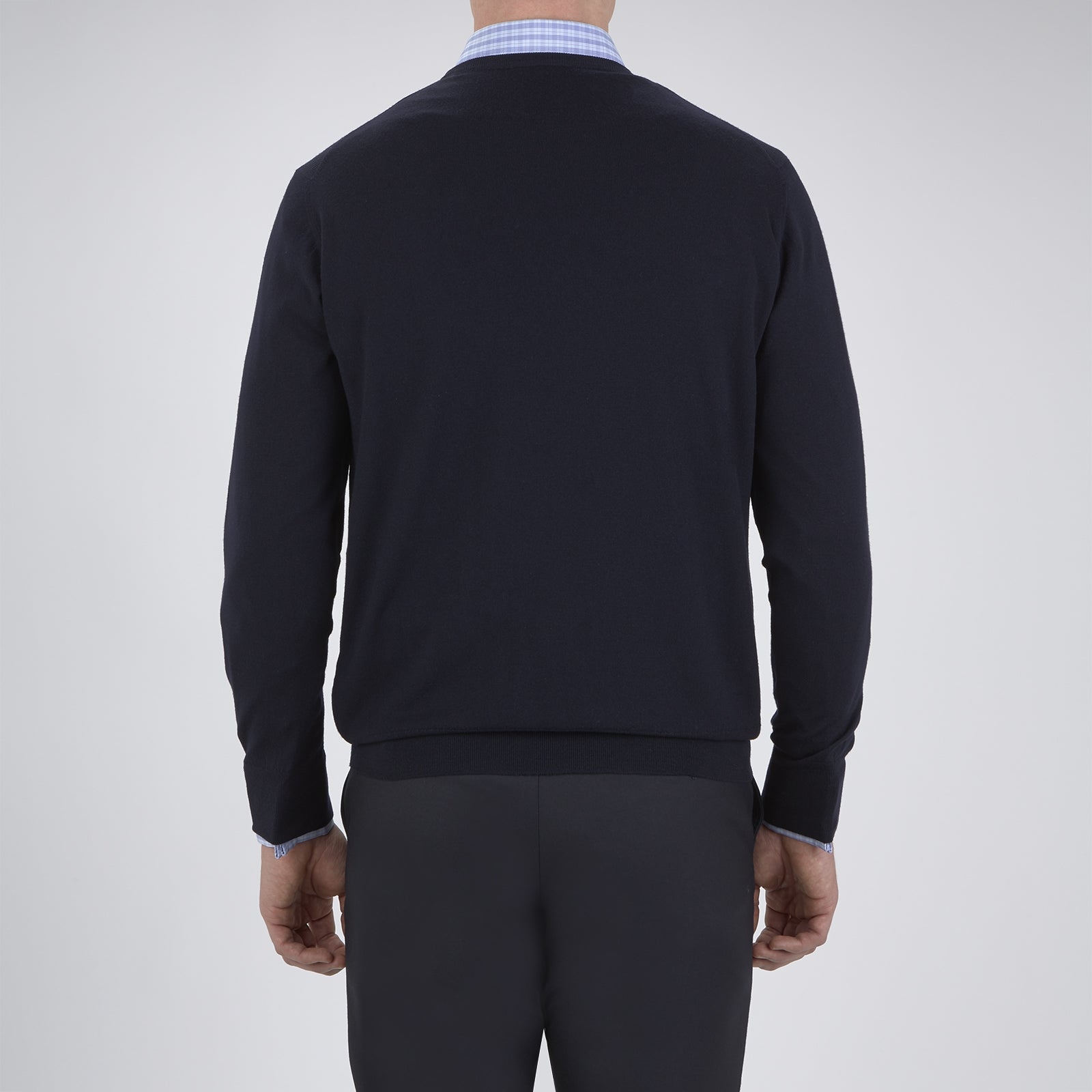 Image 3 of product A neatly folded Indigo Crew Neck Merino Wool Jumper by Turnbull & Asser, featuring a visible brand label at the collar and one sleeve tucked across the front, displayed on a white background—a versatile staple for any gentleman's wardrobe.
