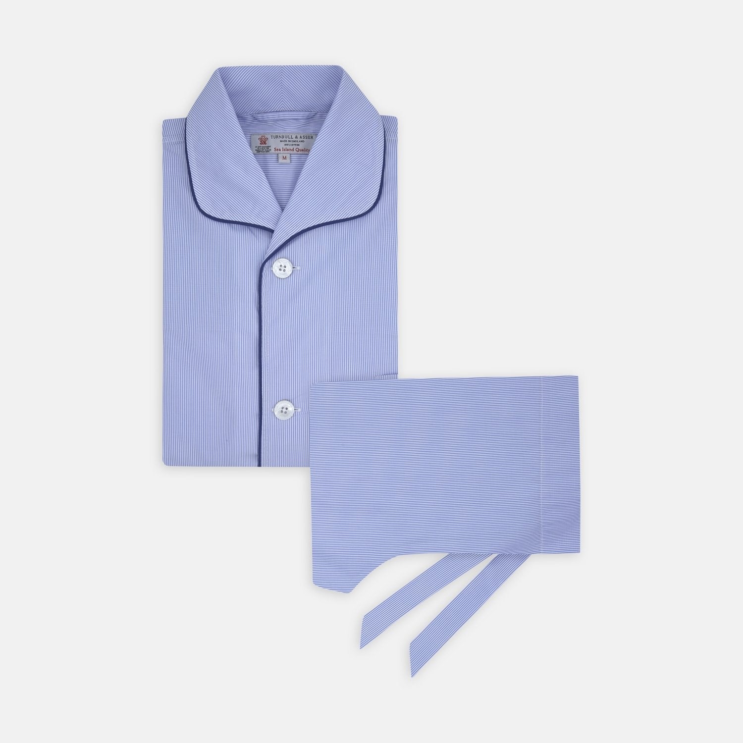 Image 1 of product The Turnbull & Asser Blue Fine Stripe Piped Sea Island Quality Cotton Pyjama Set, featuring a button-up shirt and matching nightcap, is neatly folded and displayed on a plain white background.