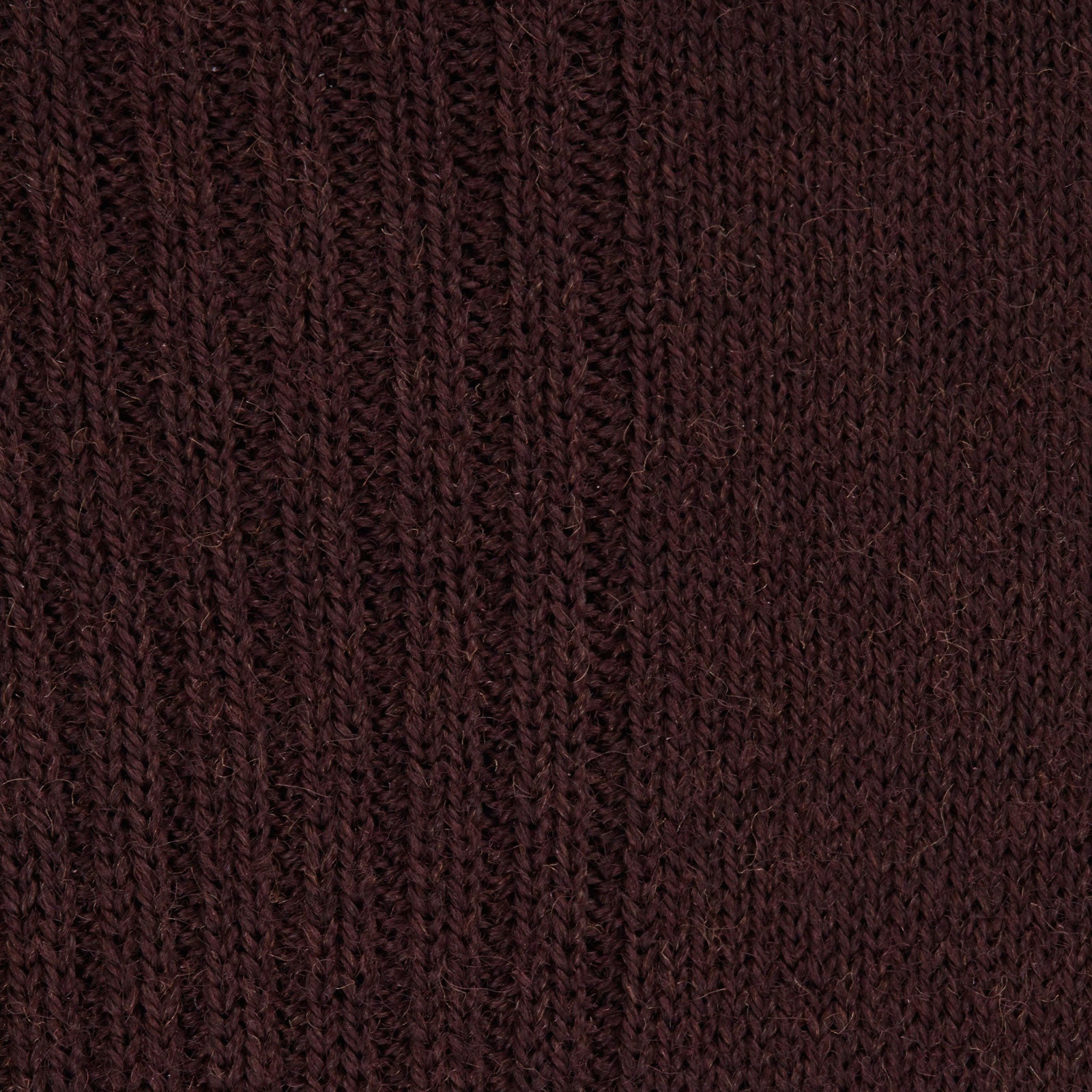 Image 2 of product A single maroon mid-length Merino wool sock from Turnbull & Asser stands upright on a plain light gray background, highlighting its ribbed texture.