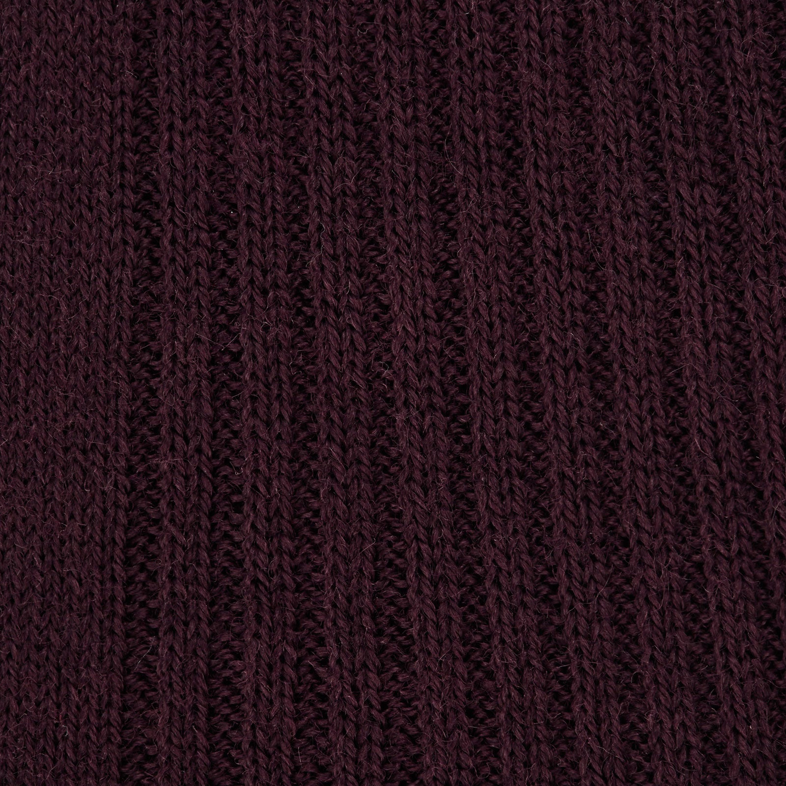 Image 2 of product Turnbull & Asser’s Maroon Long Merino Wool Sock stands upright on a white background, highlighting its ribbed texture and snug fit—ideal for those seeking luxury, comfort, and style.