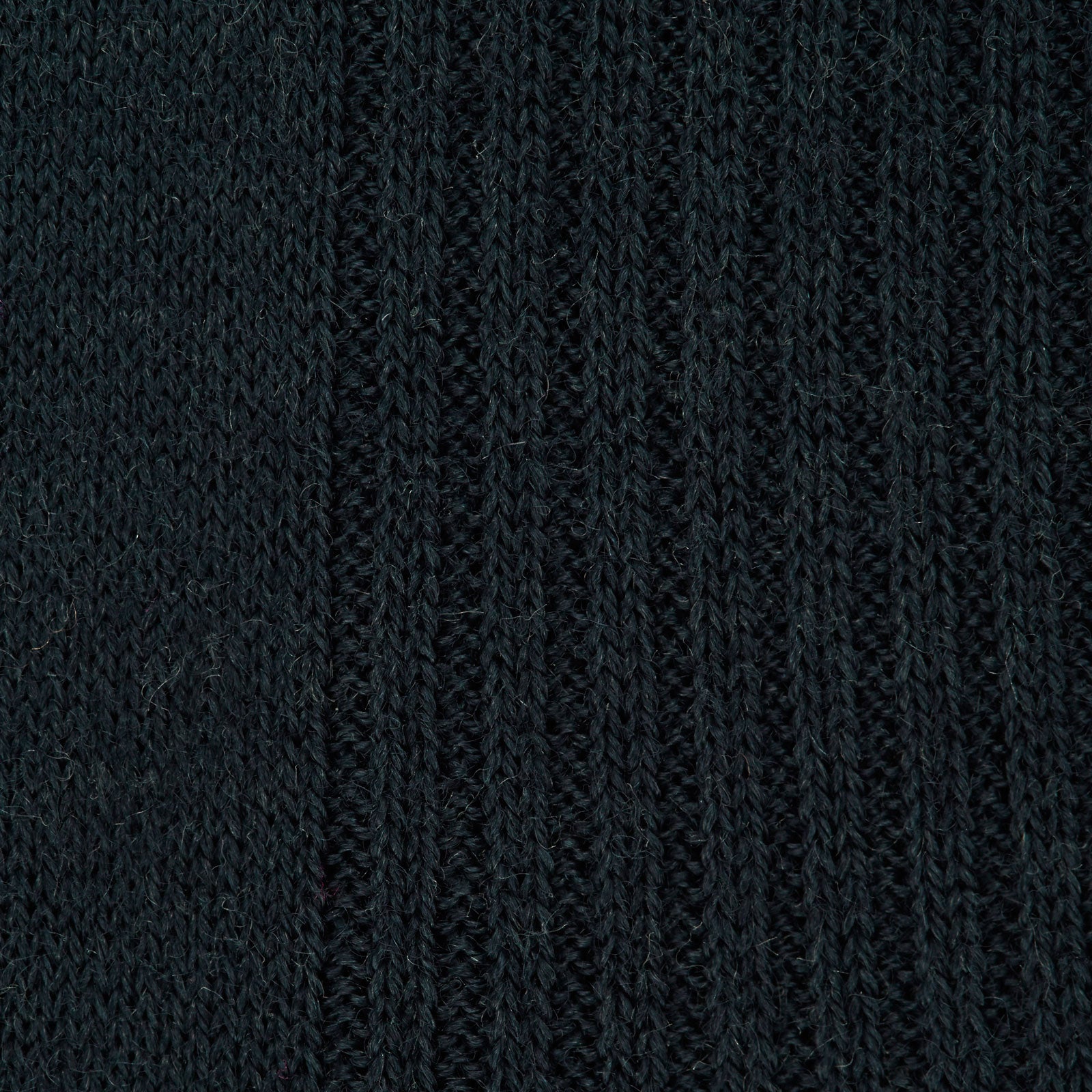 Image 2 of product A single Racing Green Long Merino Wool Sock by Turnbull & Asser is shown on a light gray background, positioned as if worn to highlight its ribbed texture and comfortable fit.